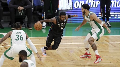 Kyrie Irving and Jayson Tatum in action during Brooklyn Nets v Boston Celtics