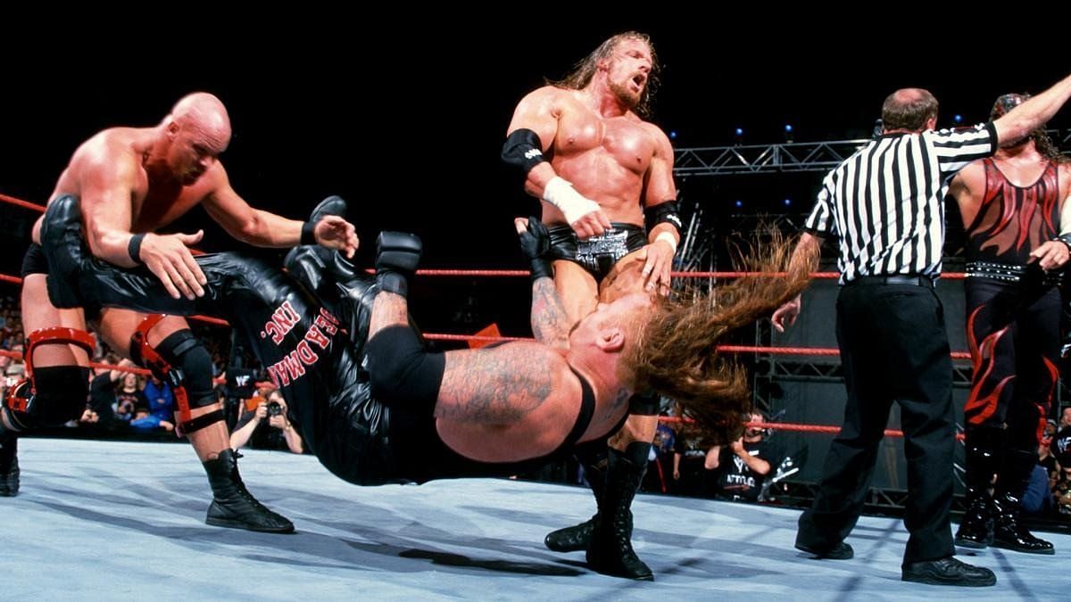 Austin and Triple H attack The Undertaker behind the referee&#039;s back