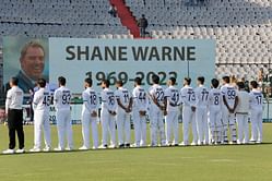 Indian and Sri Lankan players observe a minute's silence to pay respects to Shane Warne before play on Day 2