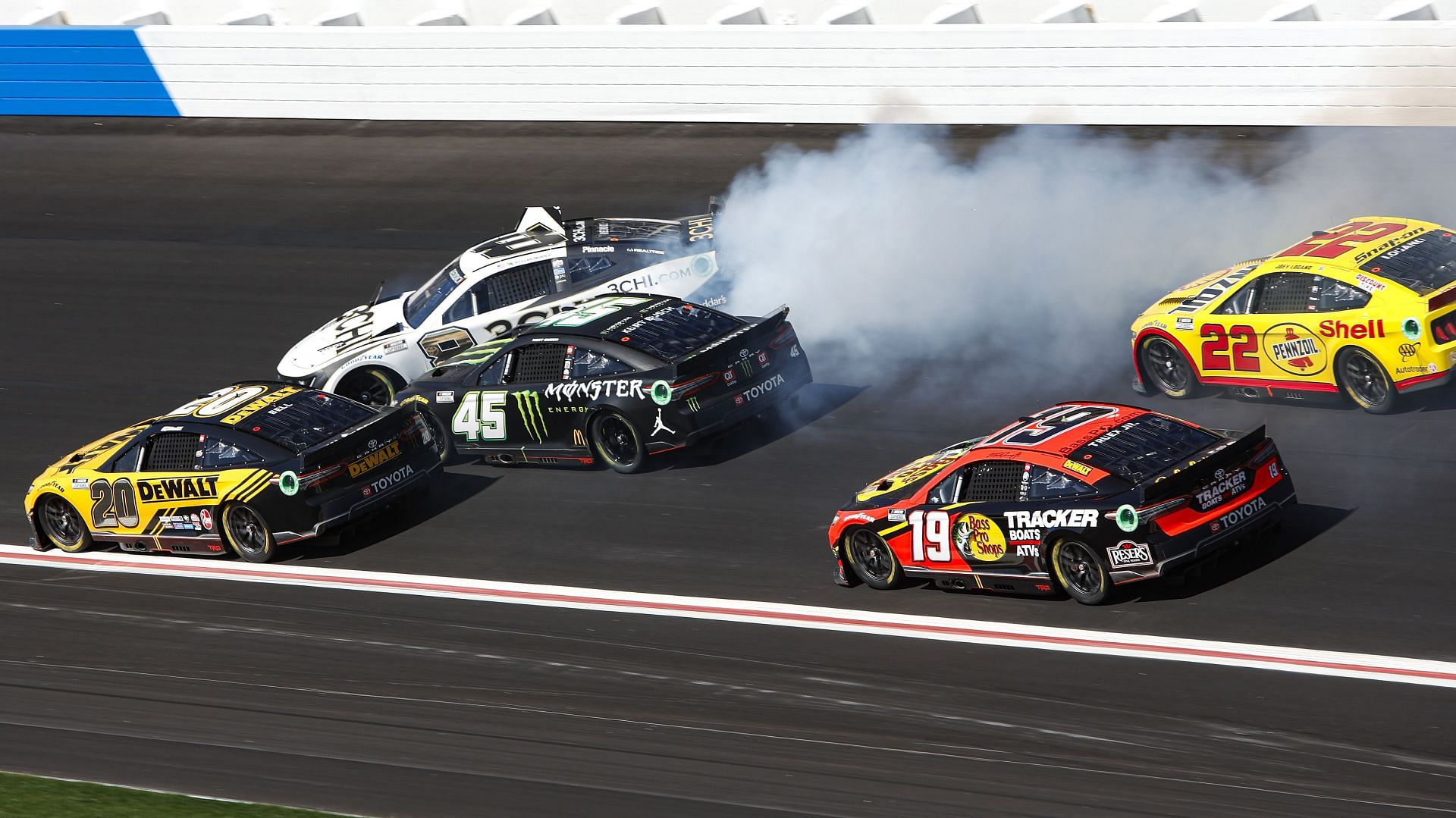 Tyler Reddick spins in front of Christopher Bell, Kurt Busch, Martin Truex Jr., and Joey Logano during the NASCAR Cup Series Folds of Honor QuikTrip 500.
