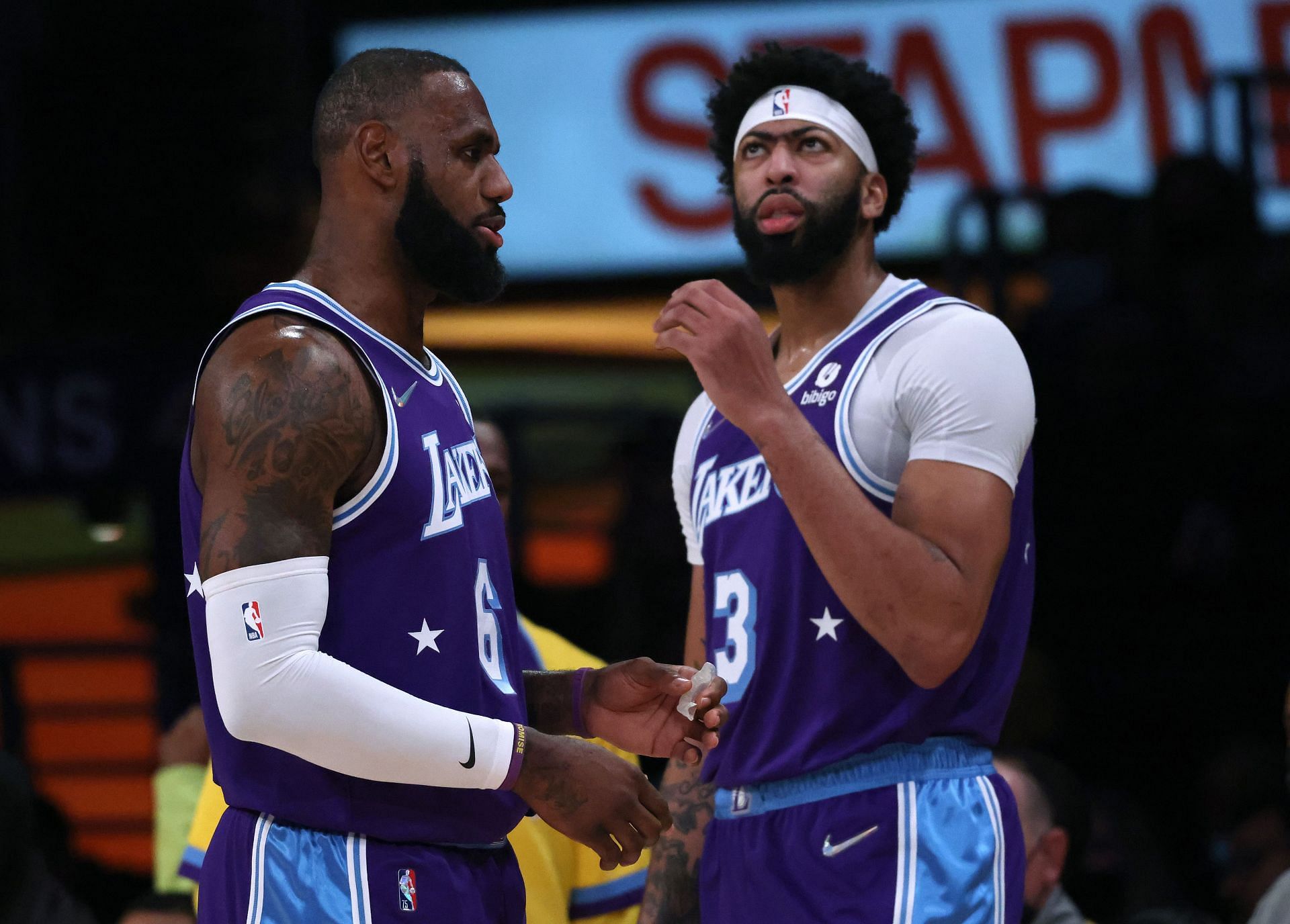 LeBron James #6 and Anthony Davis #3 of the Los Angeles Lakers react during a 119-115 Clippers win over the Los Angeles Lakers at Staples Center on December 03, 2021 in Los Angeles, California.