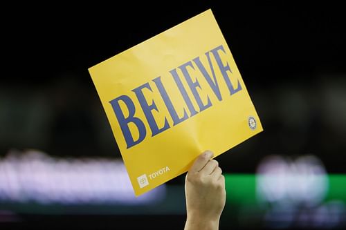 Seattle Mariners fan holds up 'BELIEVE' sign.