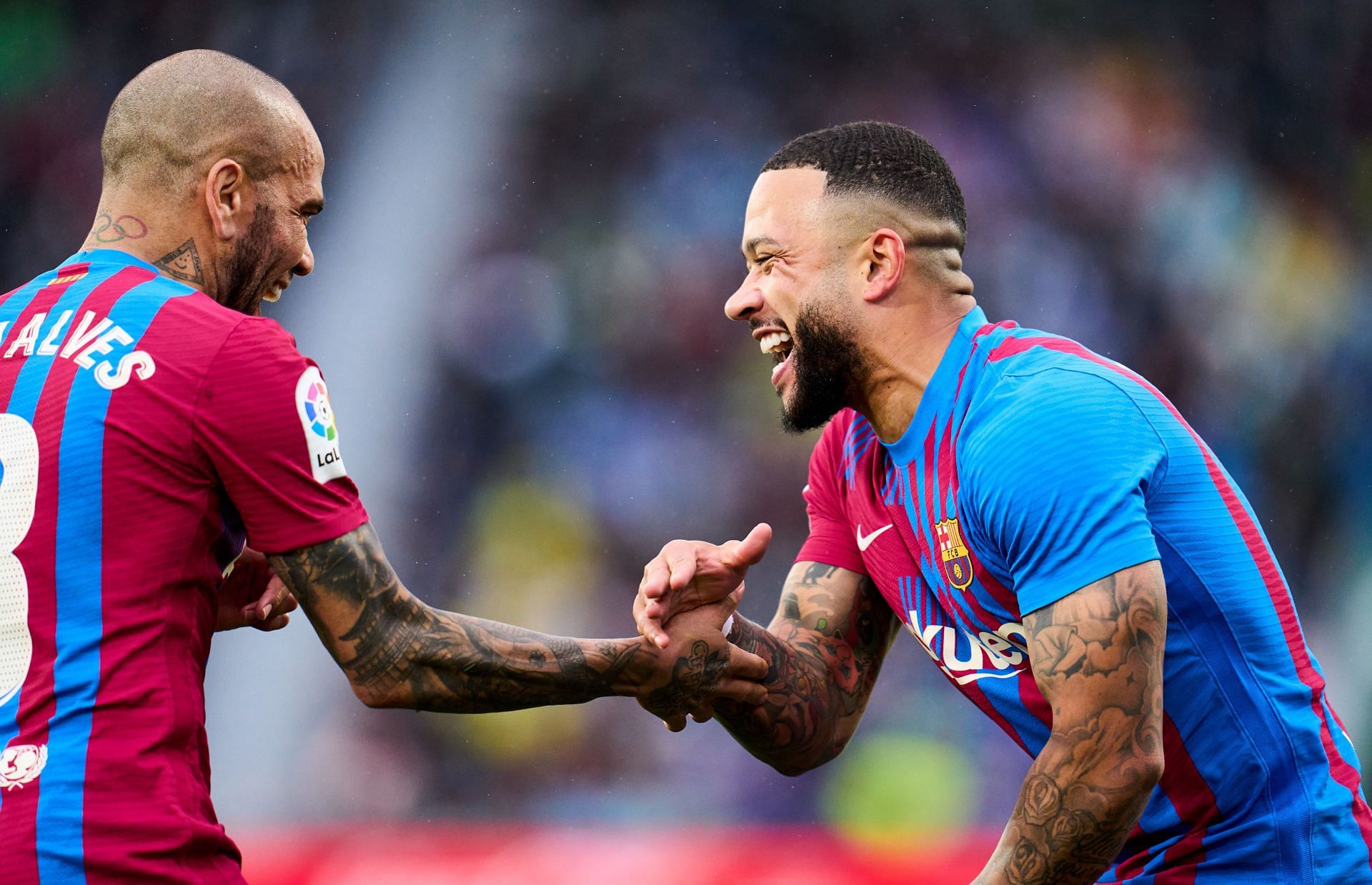 Dani Alves celebrates with Memphis Depay.