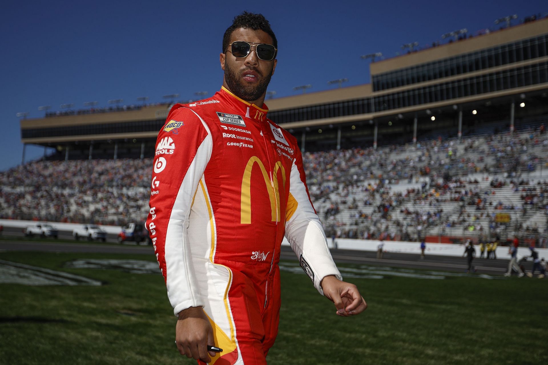 Bubba Wallace Jr. walks through the infield grass prior to the NASCAR Cup Series Folds of Honor QuikTrip 500. (Photo by Sean Gardner/Getty Images)