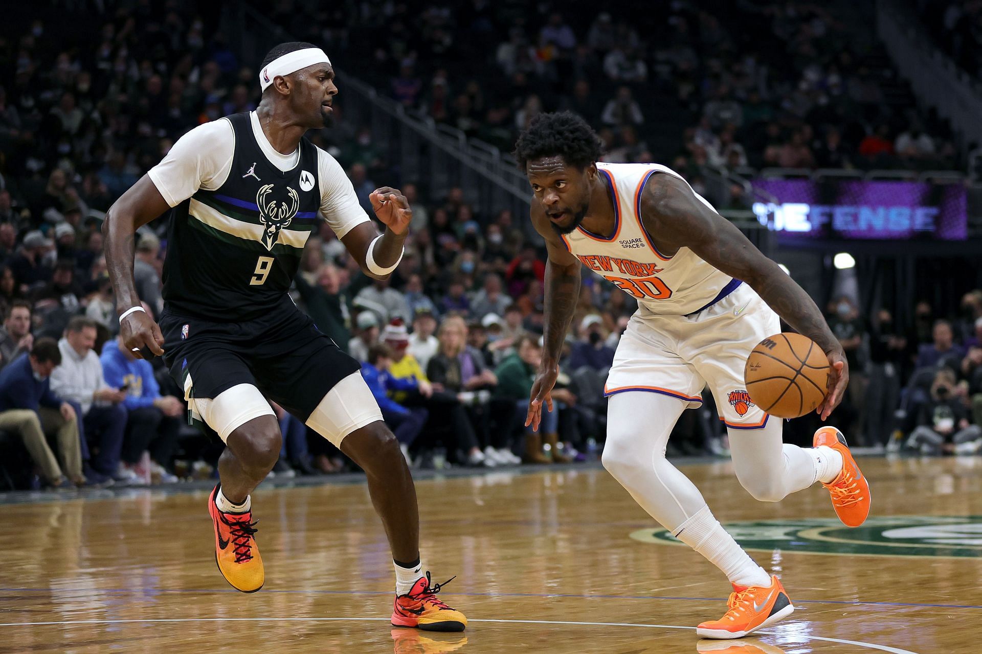 Julius Randle of the New York Knicks drives to the basket against Bobby Portis of the Milwaukee Bucks.