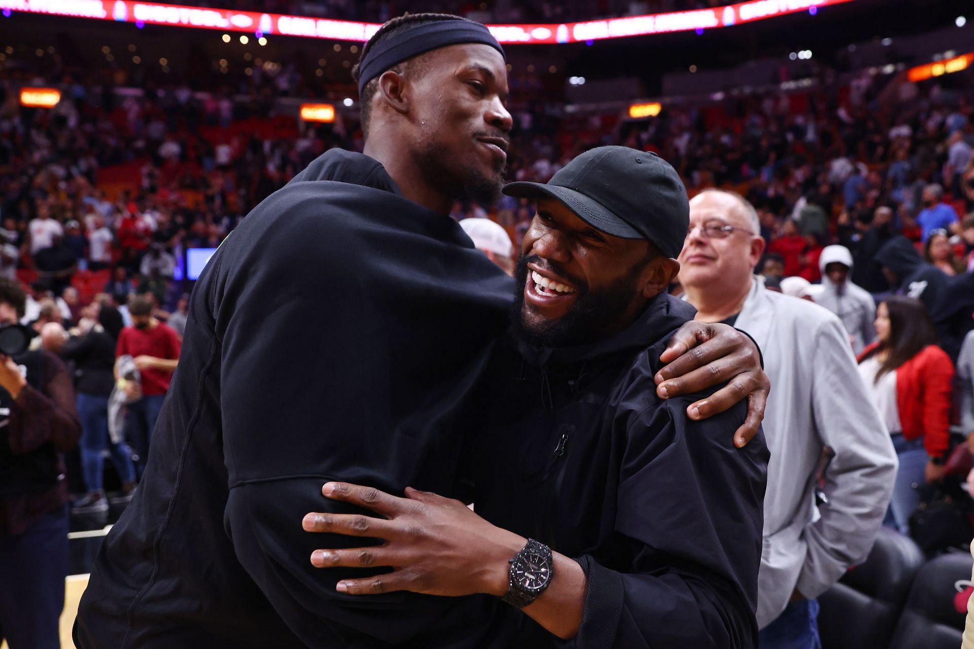 Floyd Mayweather (R) greets Miami Heat superstar Jimmy Butler (L)