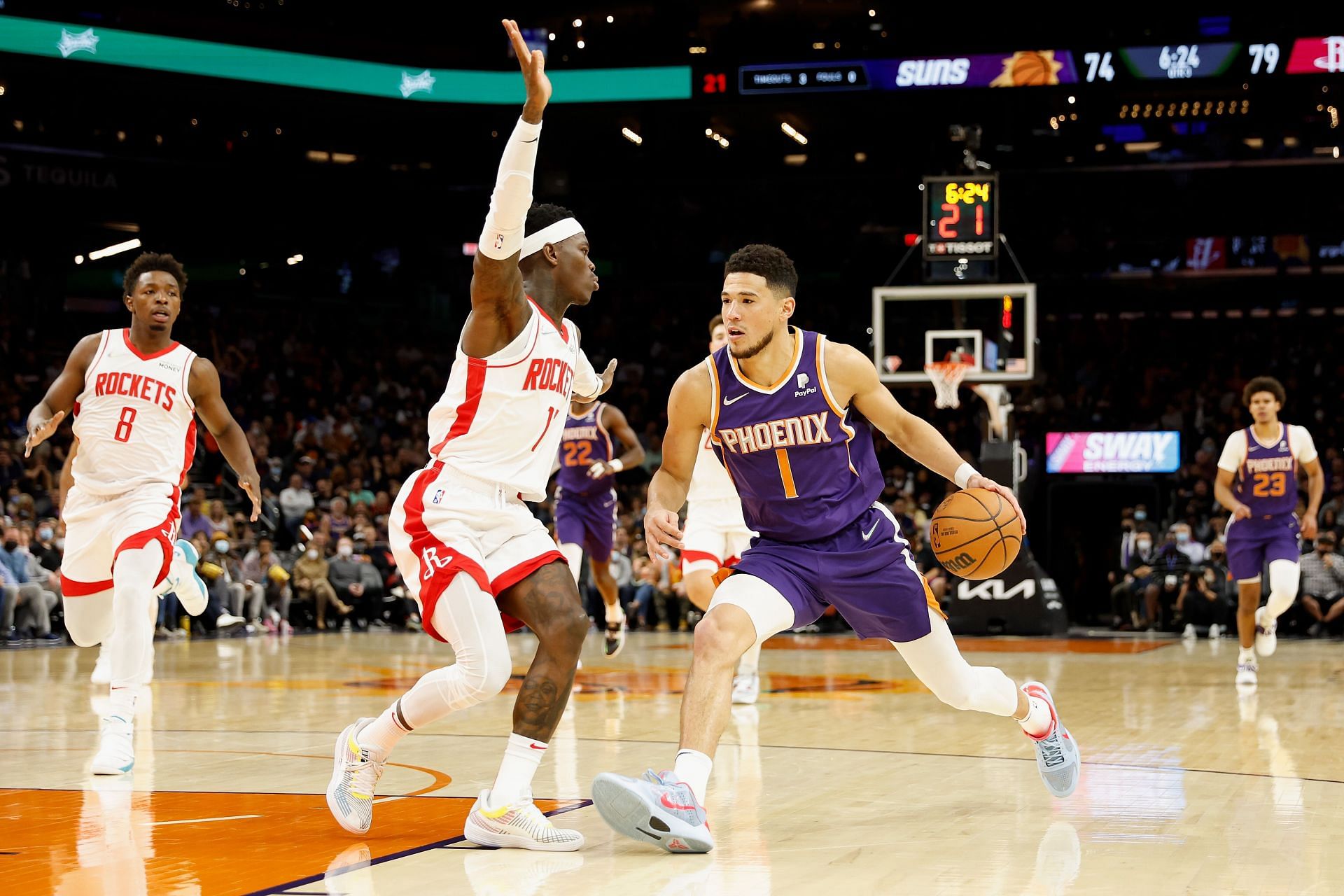 Dennis Schroder of the Houston Rockets guards Devin Booker (R) of the Sunsˆ