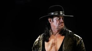 Who wrote the theme song for The Undertaker in WWE?