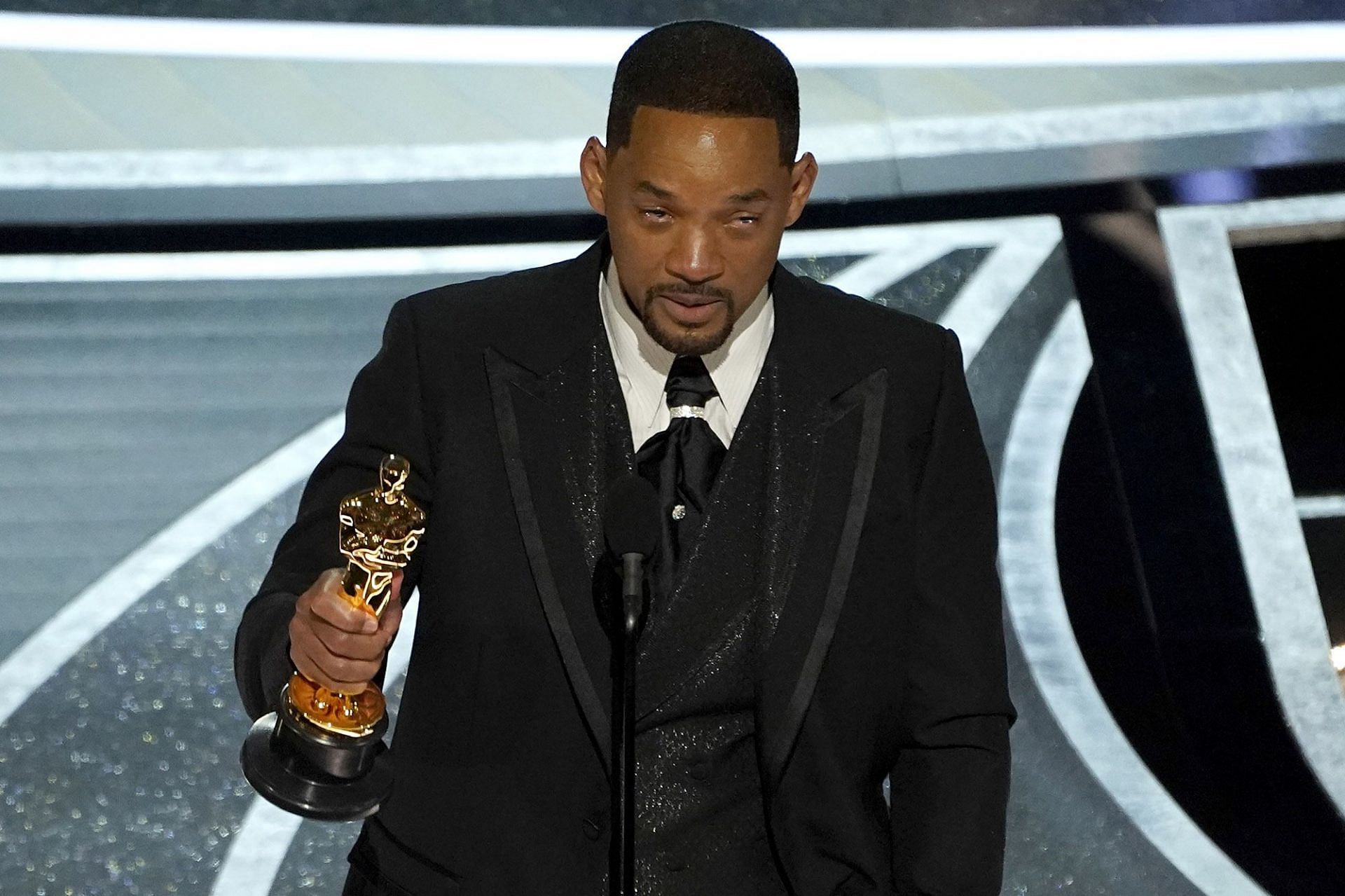  Smith tearfully accepts his Best Actor Oscar trophy for his role in &quot;King Richard.&quot; [Image via The New York Post]