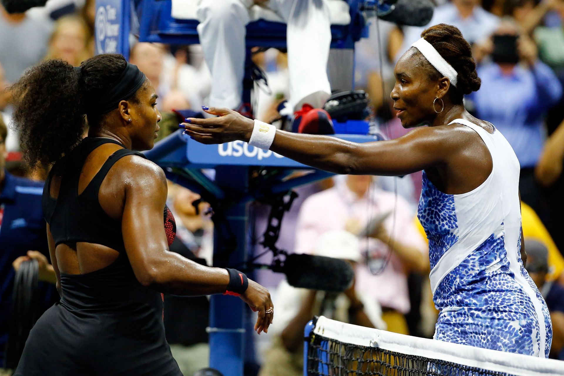 Serena Williams and Venus Williams embrace after their 2015 U.S. Open encounter