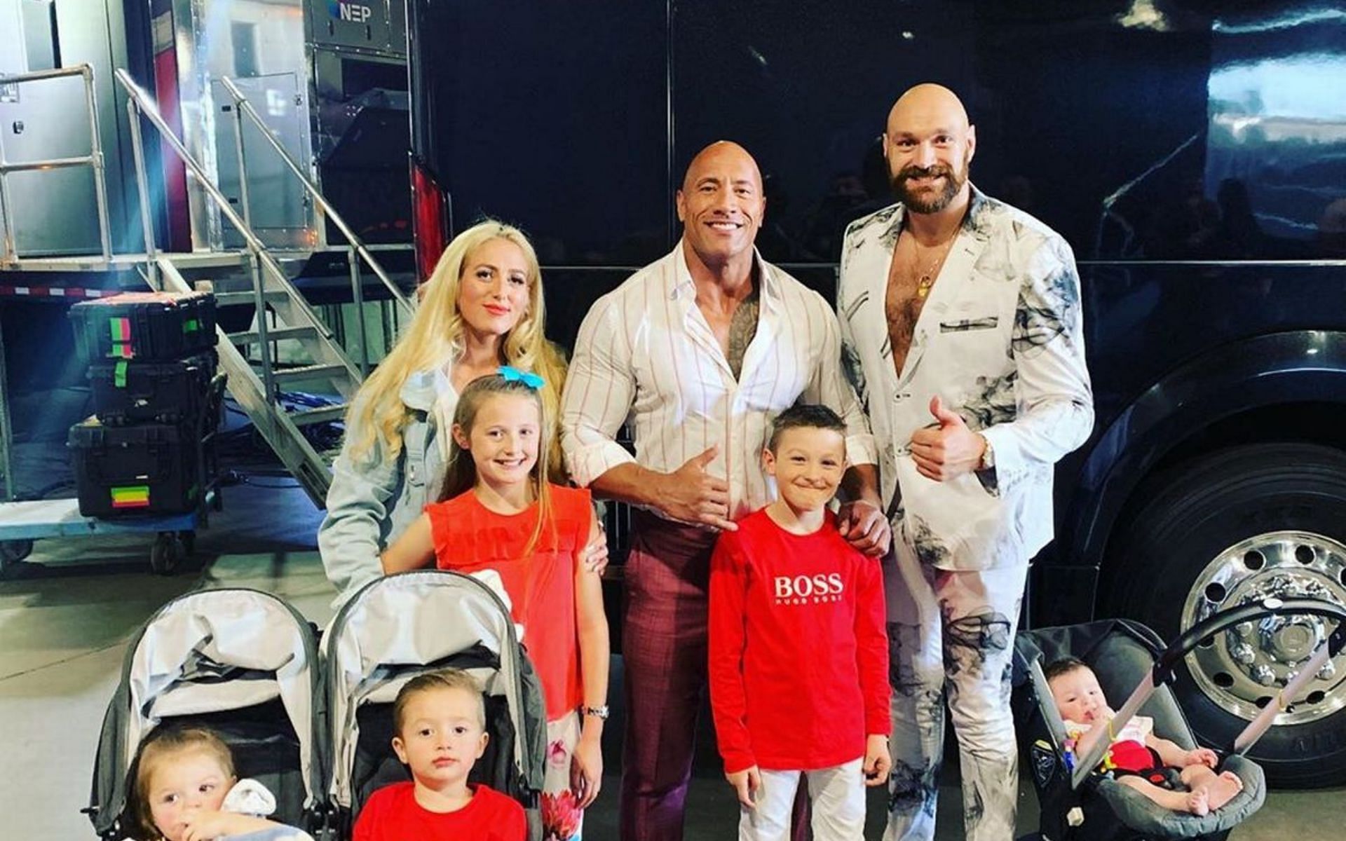 Tyson Fury and his family pose for a picture with The Rock