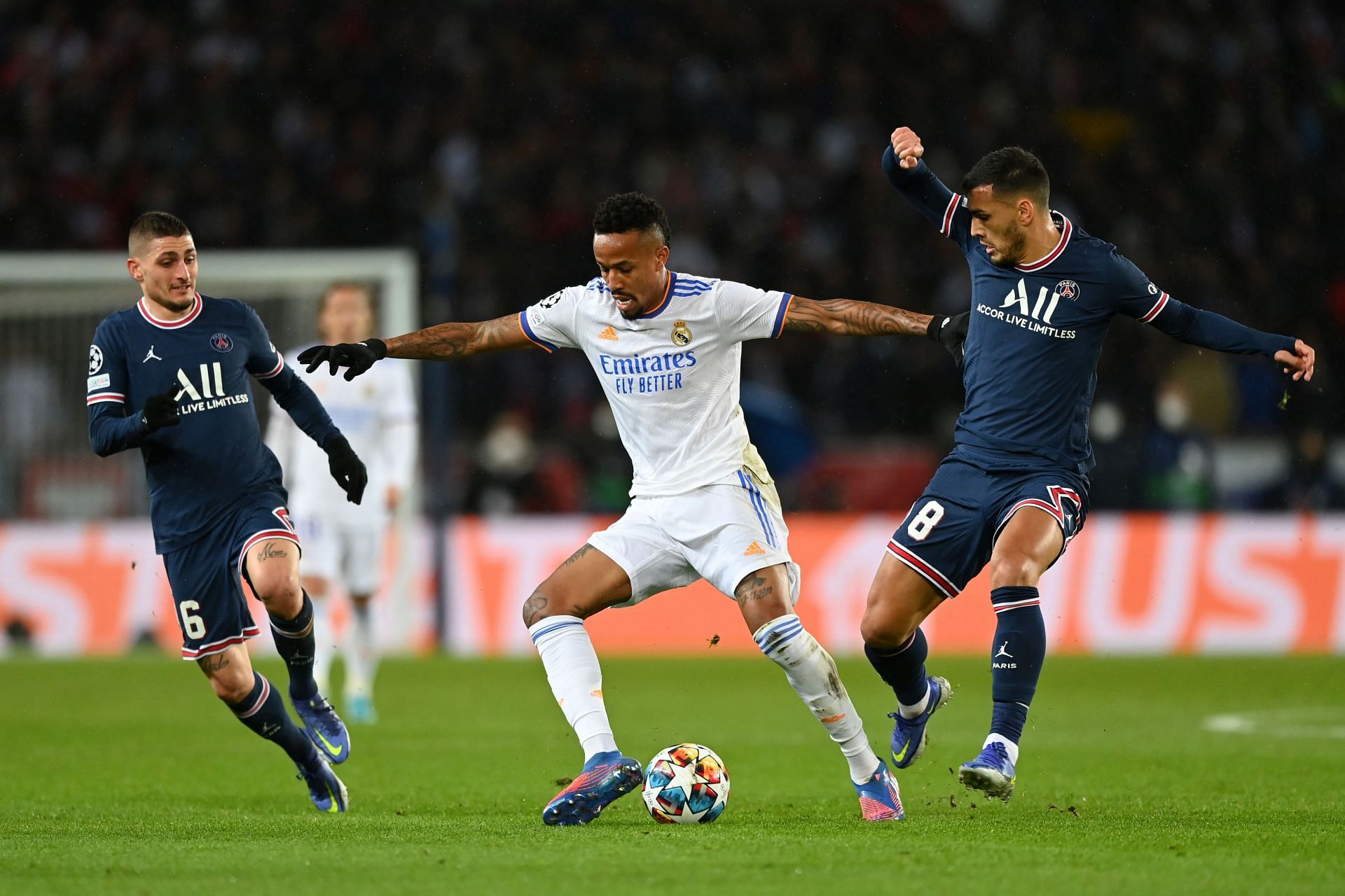  Eder Militao of Real Madrid is challenged by Marco Verratti (left) and Leandro Paredes (right) of PSG