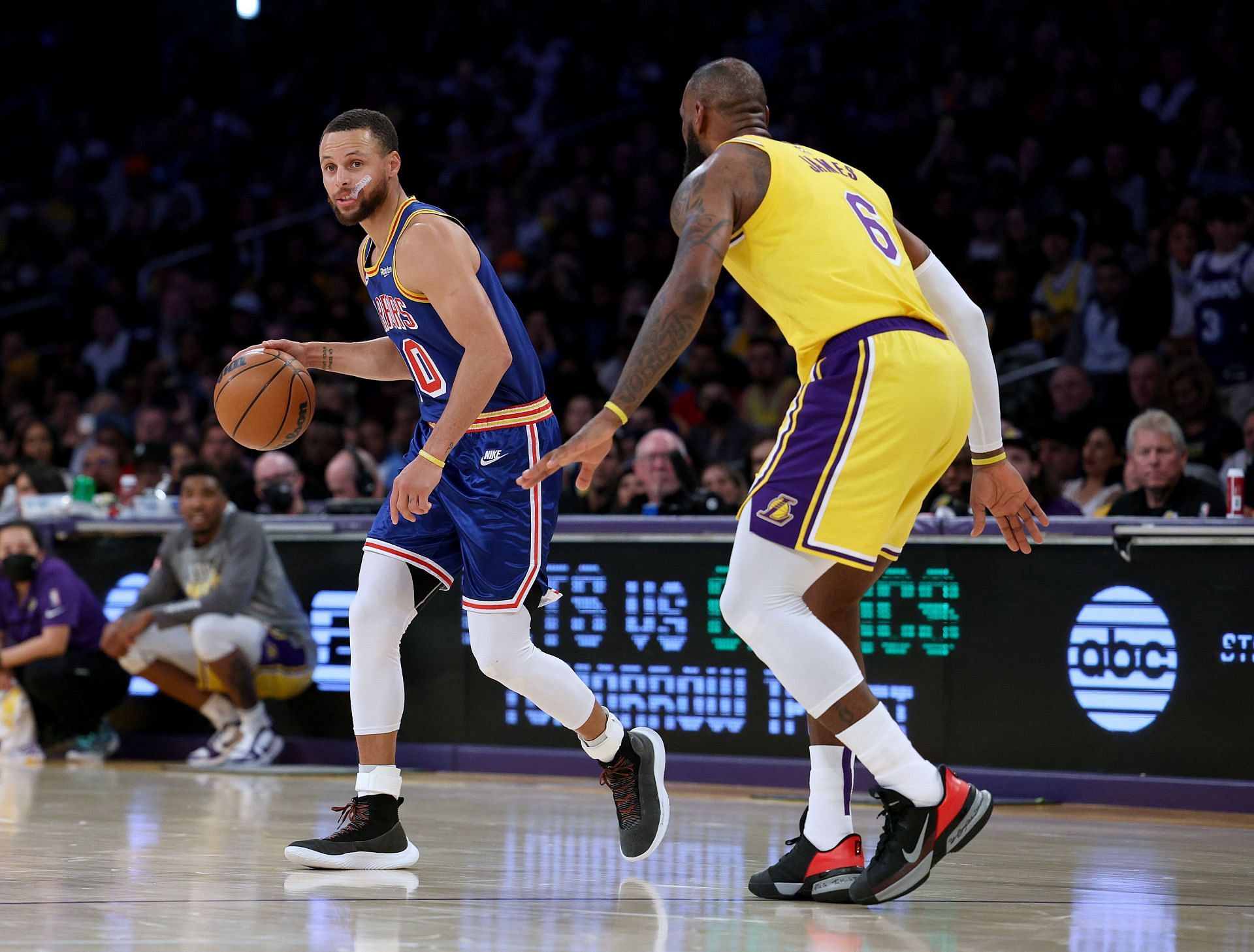 Steph Curry of the Golden State Warriors dribbles in front of LeBron James of the LA Lakers during the first half on March 5 in Los Angeles, California.