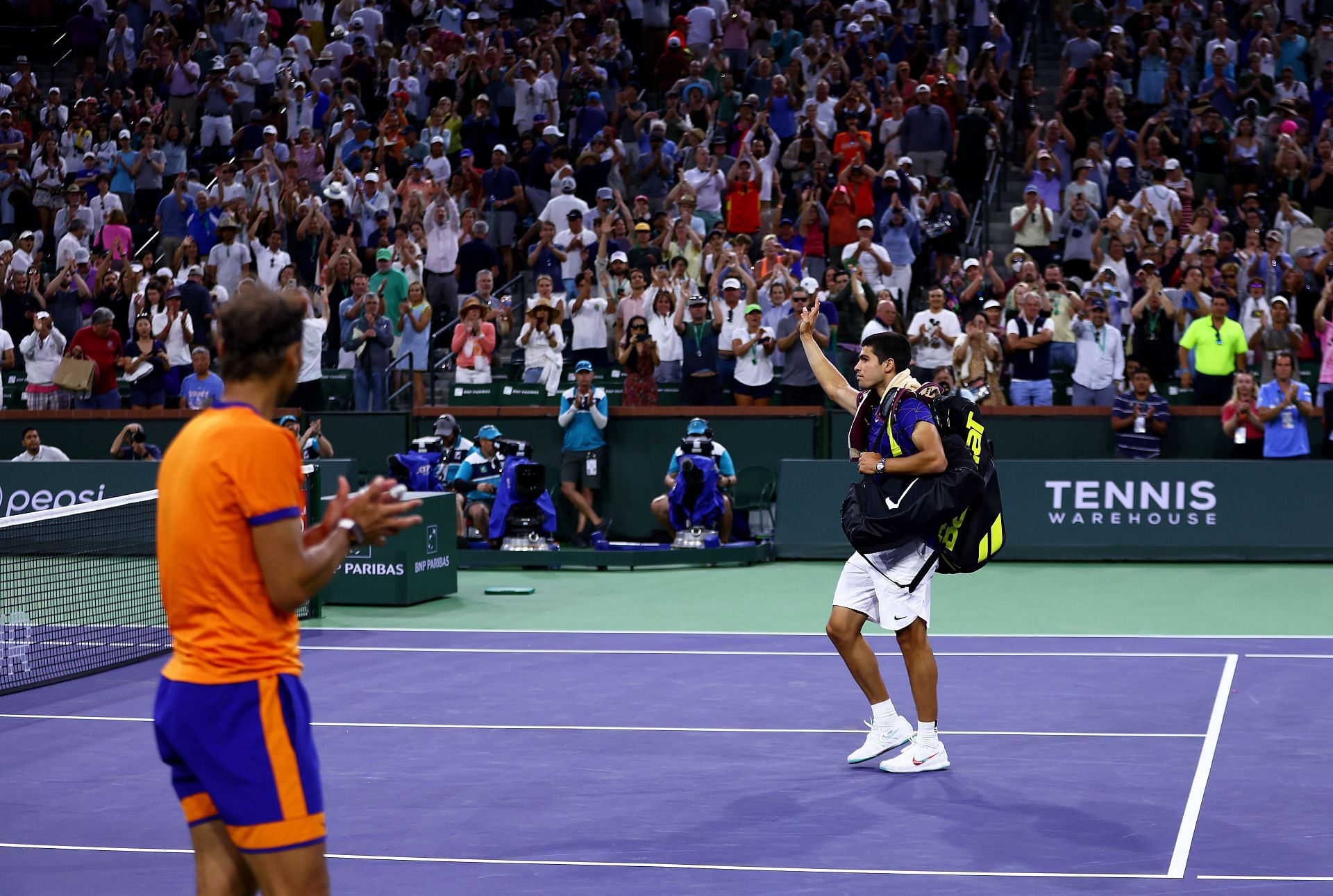 Rafael Nadal applauds Carlos Alcaraz as he leaves the court after their semi-final match