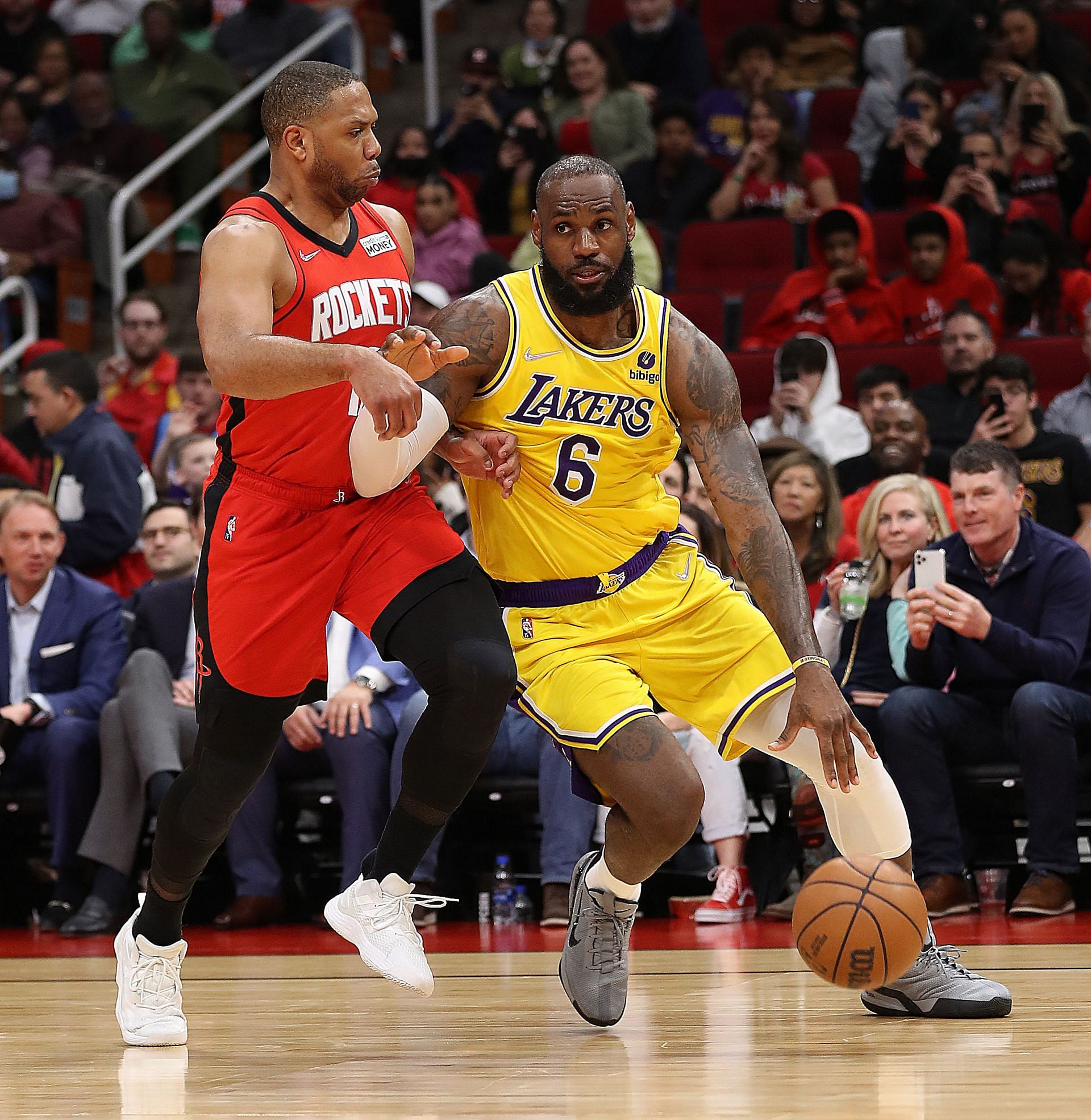 LeBron James of the LA Lakers dribbles baseline on Eric Gordon of the Houston Rockets during the fourth quarter at Toyota Center on Wednesday in Houston, Texas.