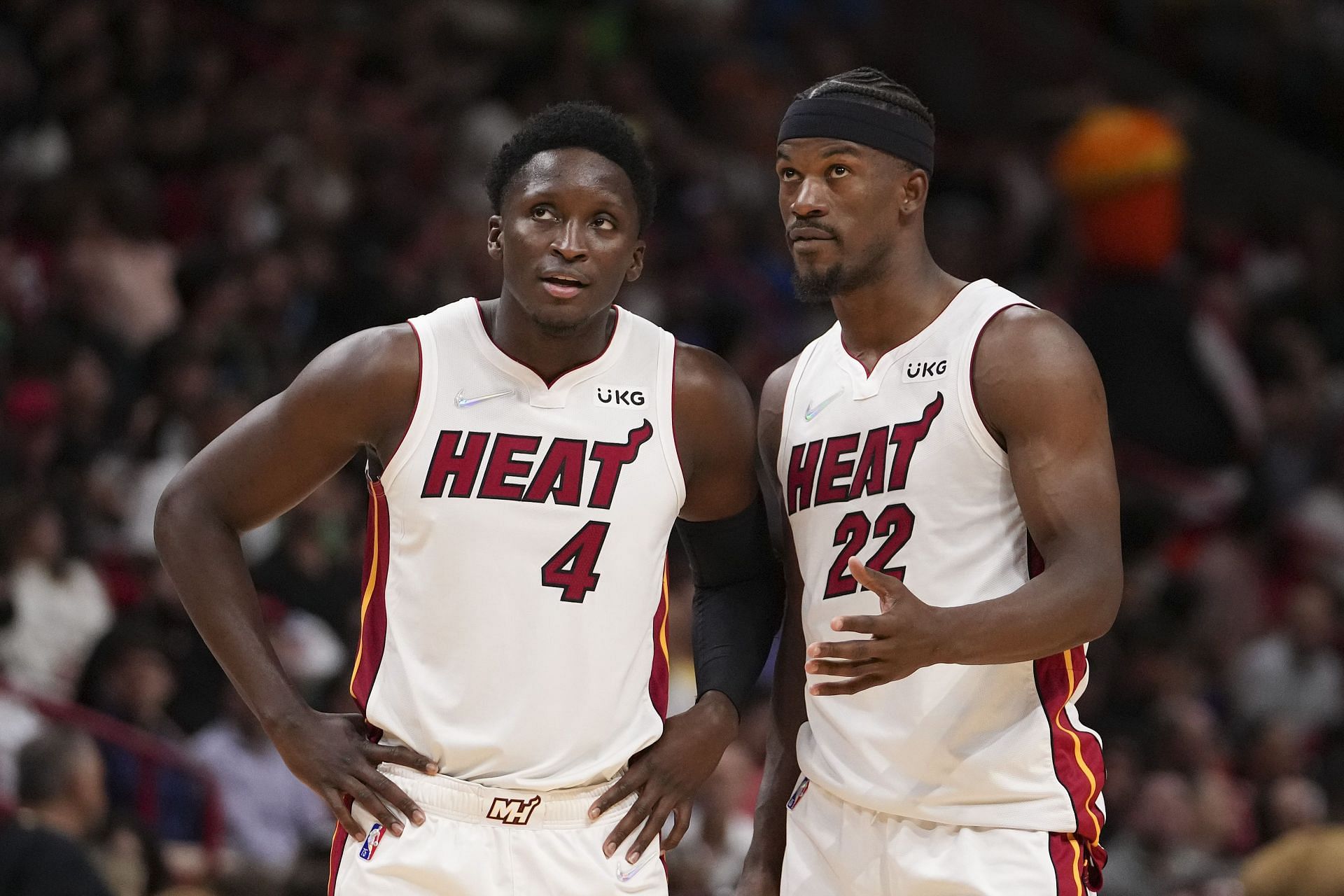 Jimmy Butler #22 and Victor Oladipo #4 of the Miami Heat talk during a free-throw attempt in the second half against the Golden State Warriors at FTX Arena on March 23, 2022 in Miami, Florida.