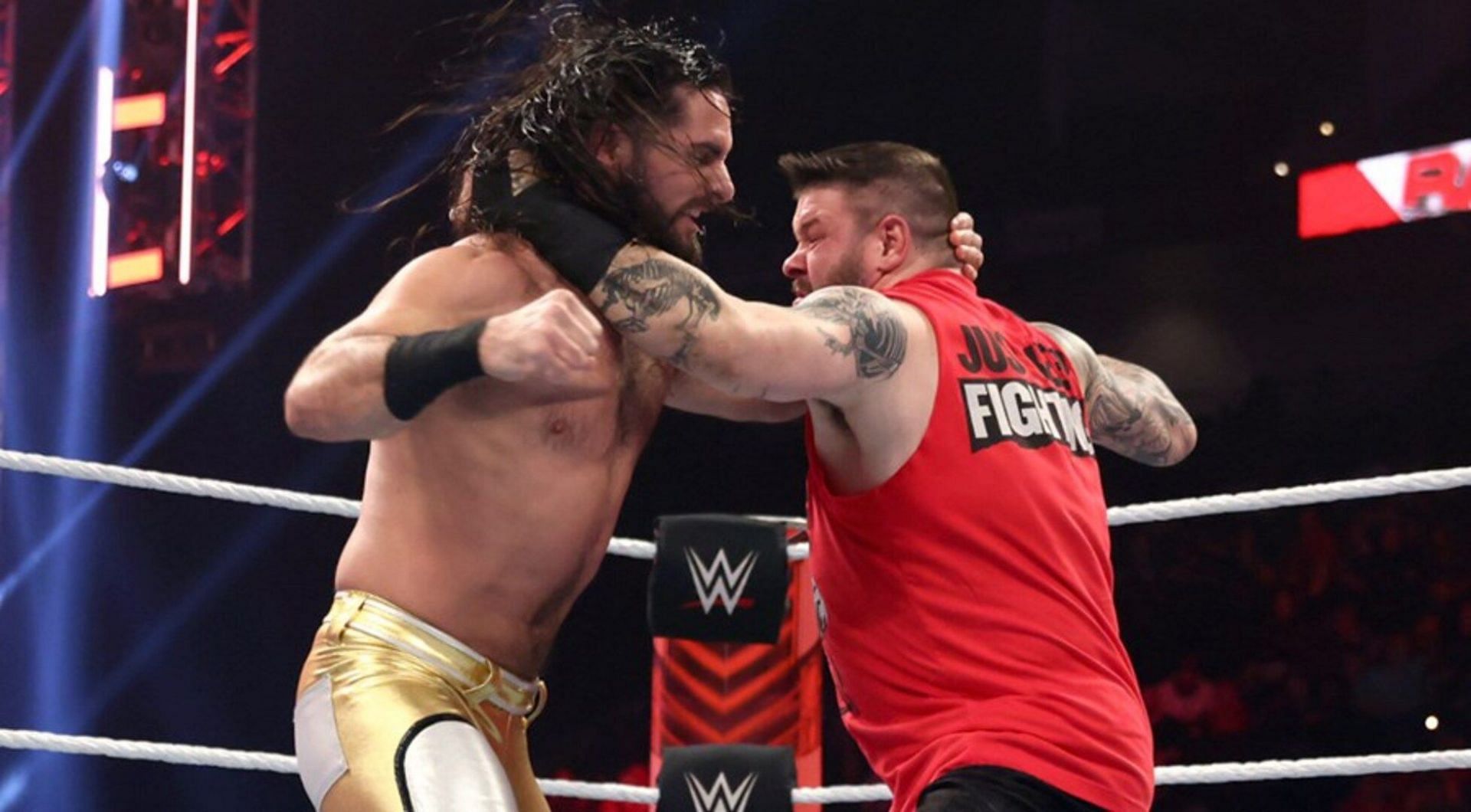 Seth Rollins and Kevin Owens exchanging blows.