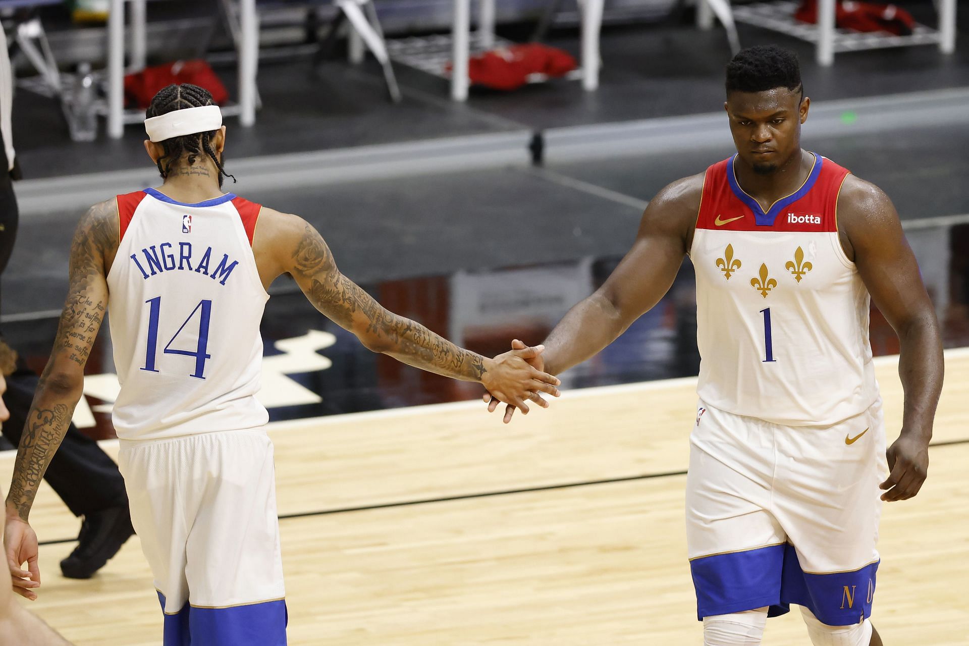 Brandon Ingram #14 and Zion Williamson #1 of the New Orleans Pelicans high five