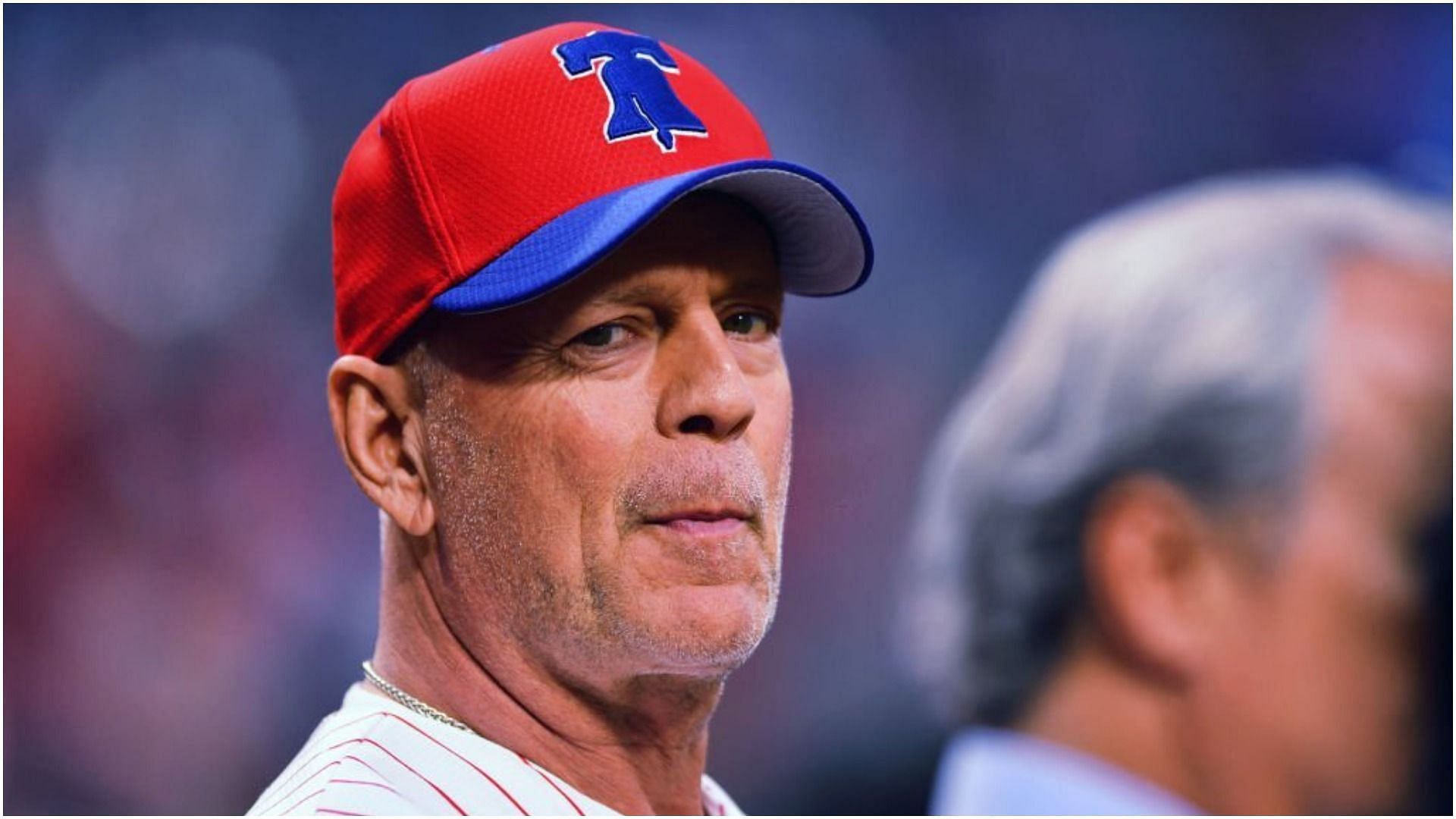 Bruce Willis looks on before throwing out the first pitch before the game between the Milwaukee Brewers and Philadelphia Phillies (Image via Kyle Ross/Getty Images)