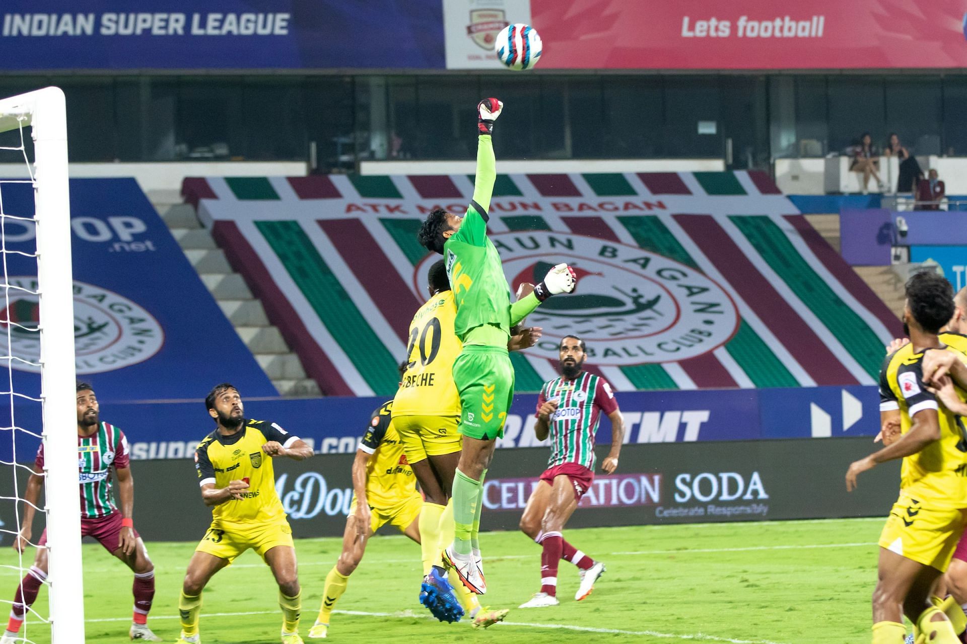 Hyderabad FC&#039;s Laxmikant Kattimani (C) punches the ball out against ATK Mohun Bagan. [Credits: ISL]