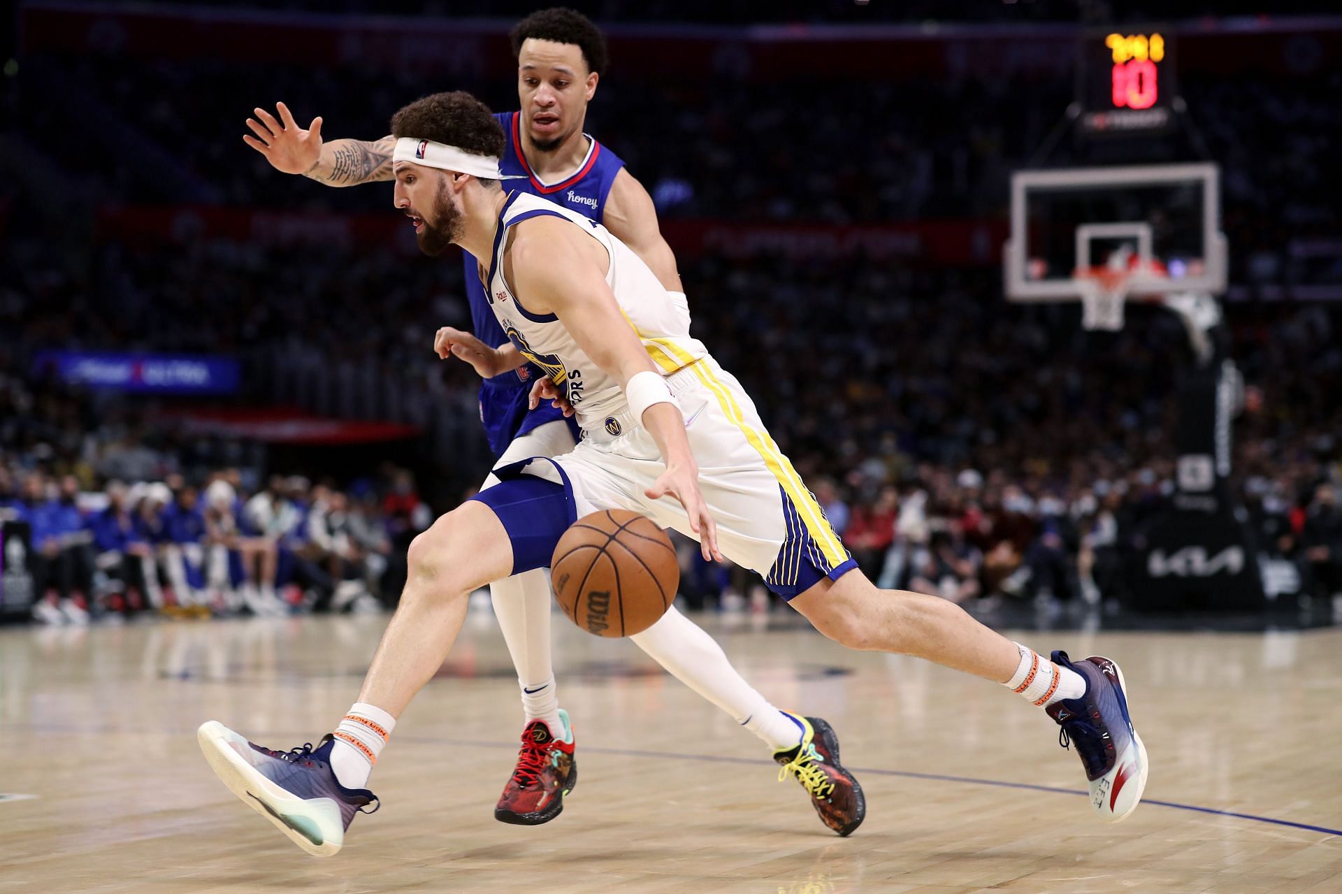 Klay Thompson #11 of the Golden State Warriors dribbles against Amir Coffey #7 of the Los Angeles Clippers