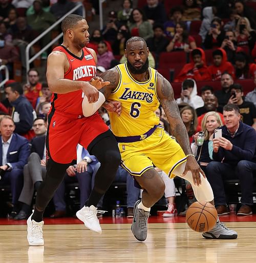 Los Angeles Lakers forwards LeBron James drives against Houston Rockets guard Eric Gordon.