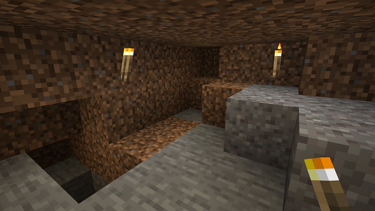 Building a hidden base can get quite dark, and players should bring a light source (Image via Minecraft)