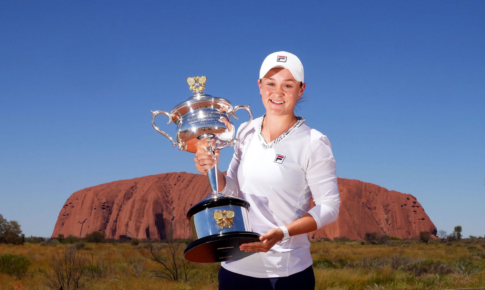 Ashleigh Barty poses with the Daphne Akhurst Memorial Cup as she visits Uluru in the Uluru-Kata Tjuta National Park