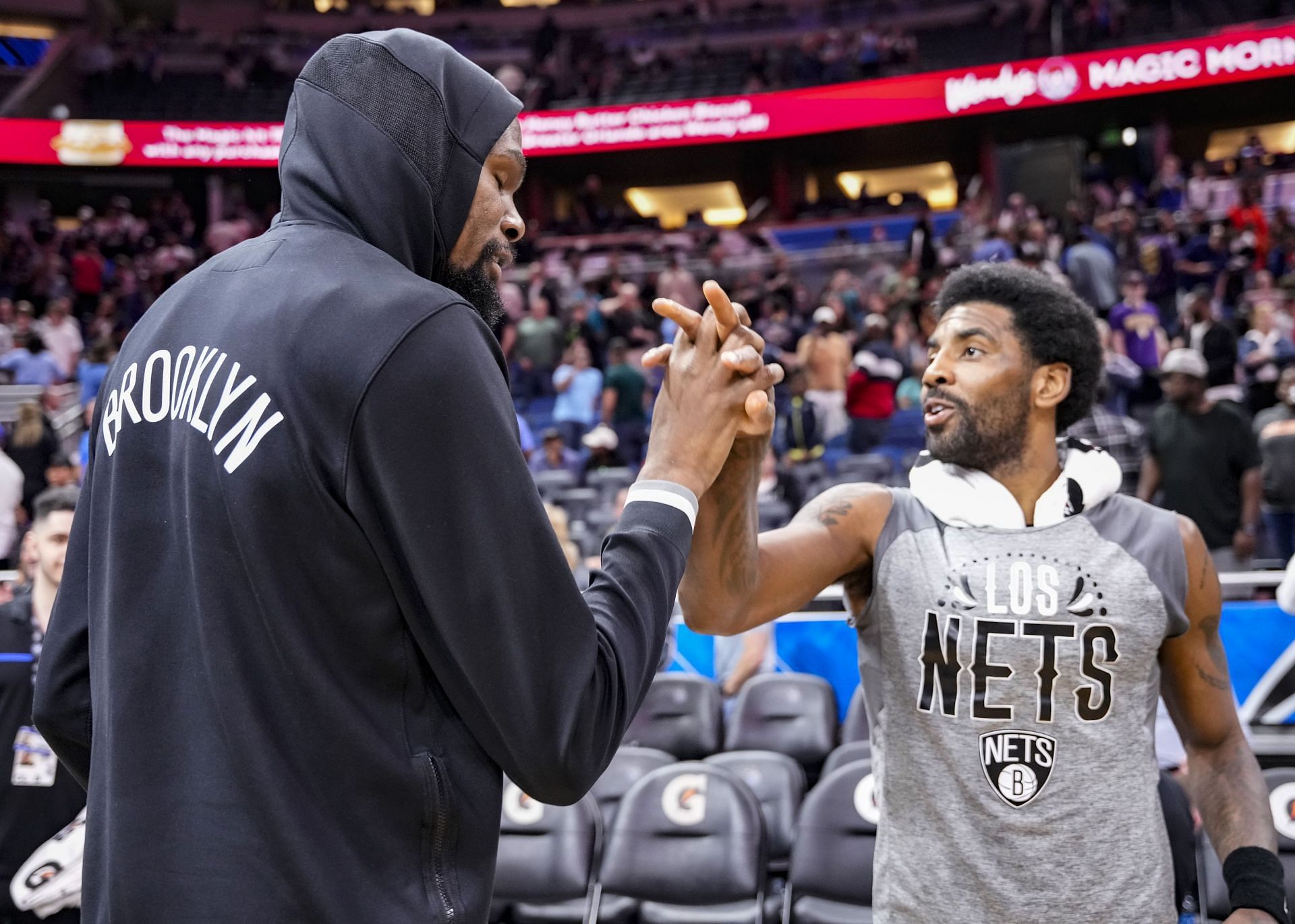 Kyrie Irving #11 of the Brooklyn Nets celebrates with Kevin Durant #7 after scoring a career high and franchise record 60 points in beating the Orlando Magic by score of 150-108 at Amway Center on March 15, 2022 in Orlando, Florida.