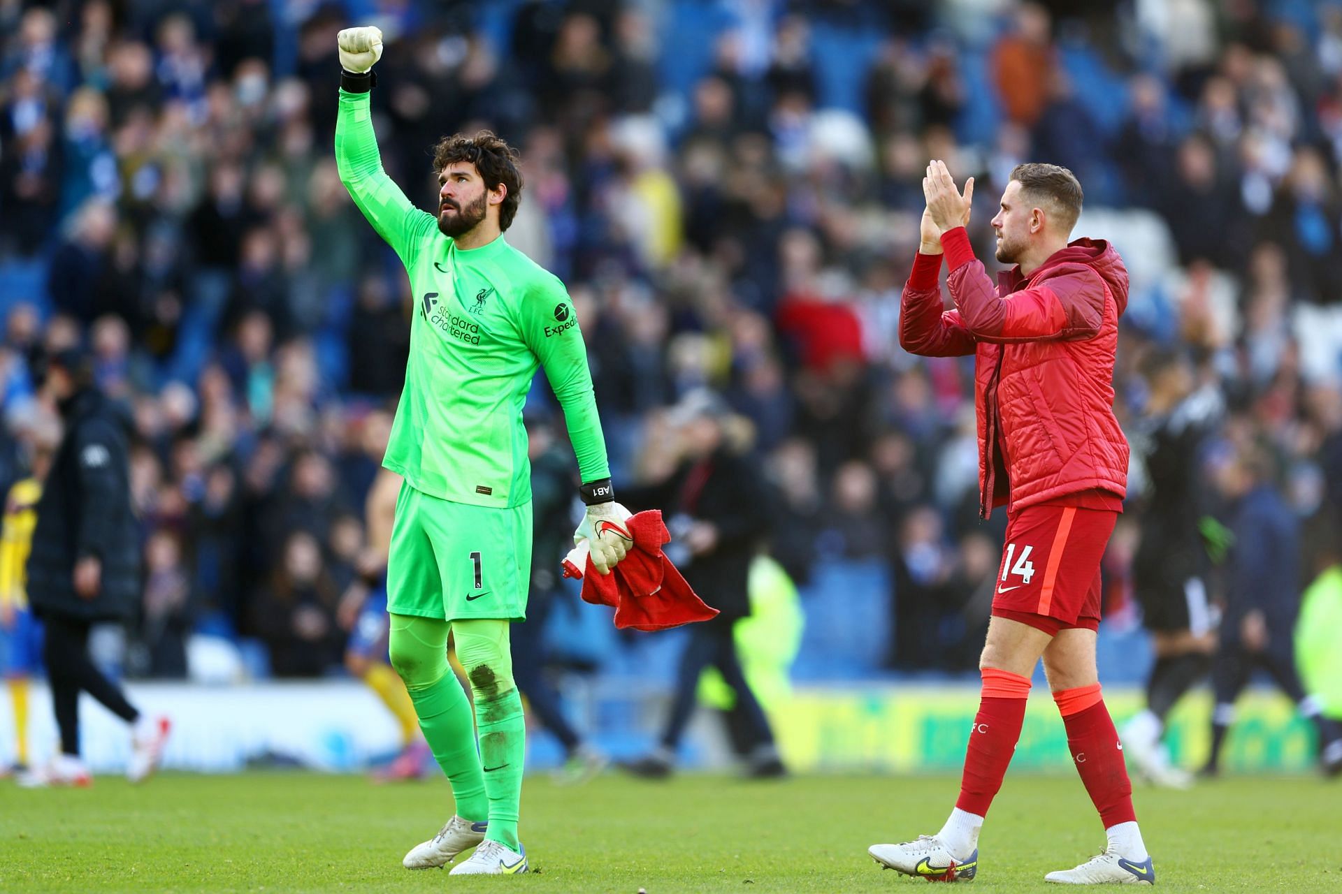 Alisson Becker and Jordan Henderson celebrate following their win over Brighton