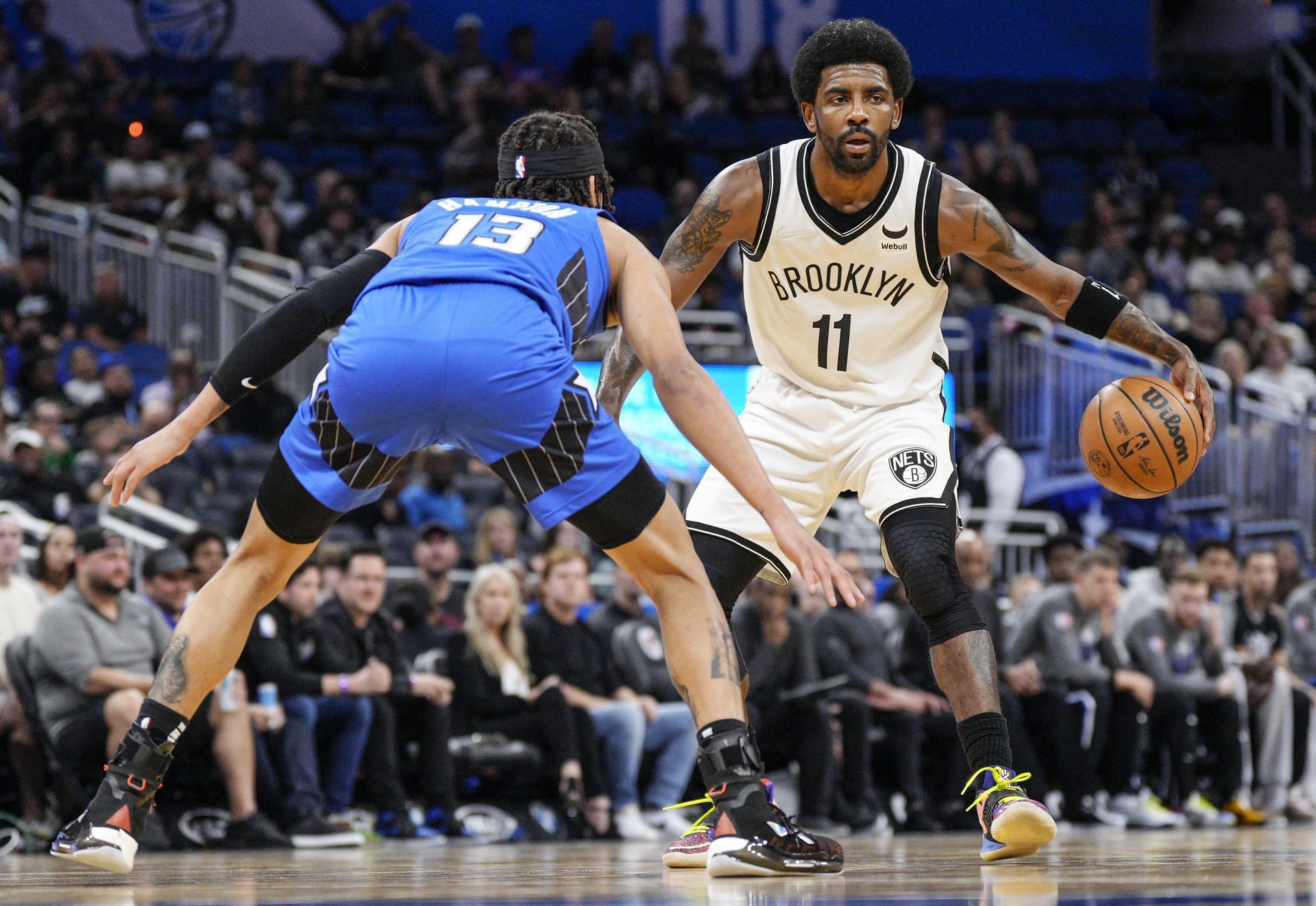 Brooklyn Nets Kyrie Irving (with ball) playing away due to vaccination duty