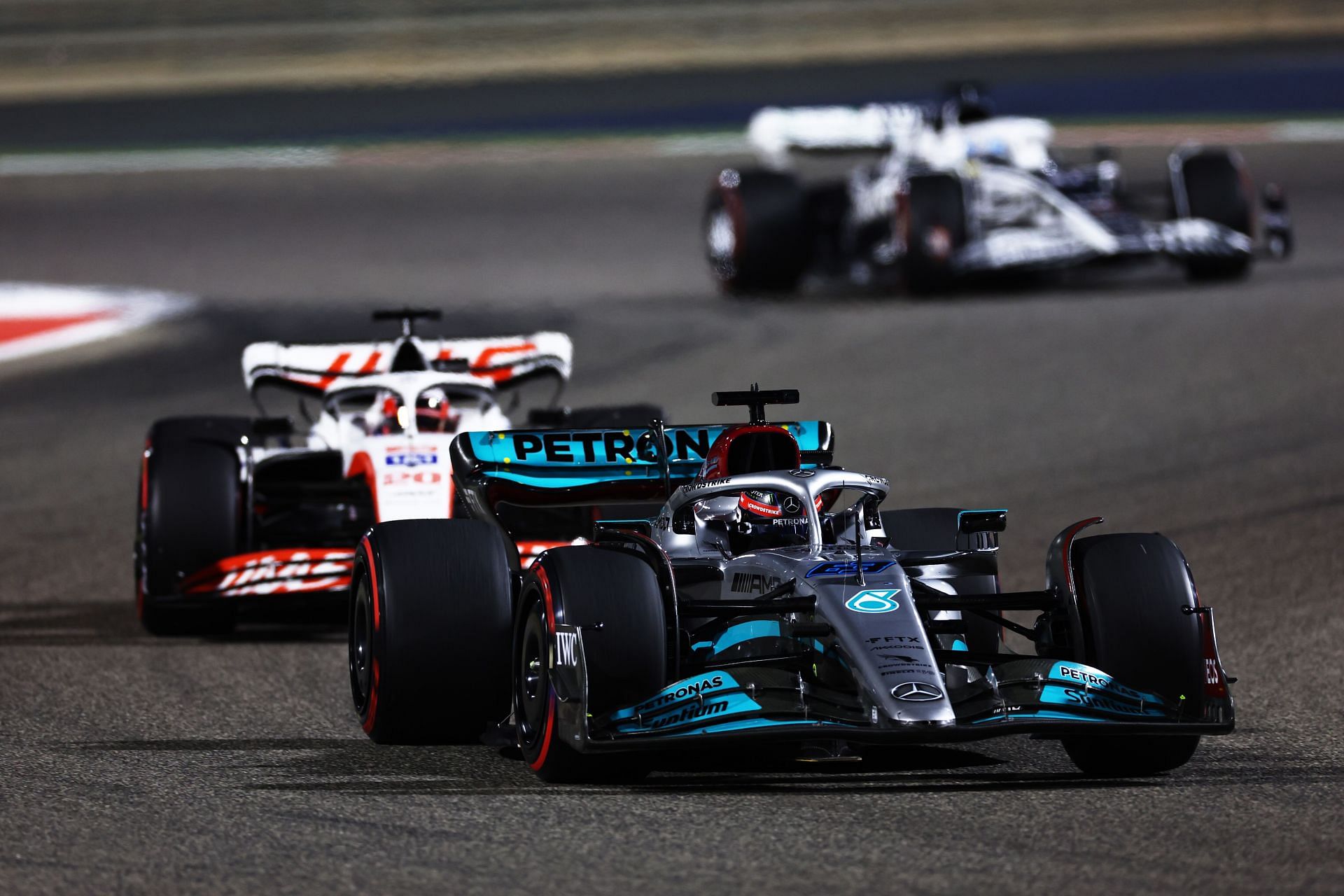 George Russell (#63) Mercedes W13, defending against Kevin Magnussen (#20) Haas VF-22, 2022 Bahrain GP