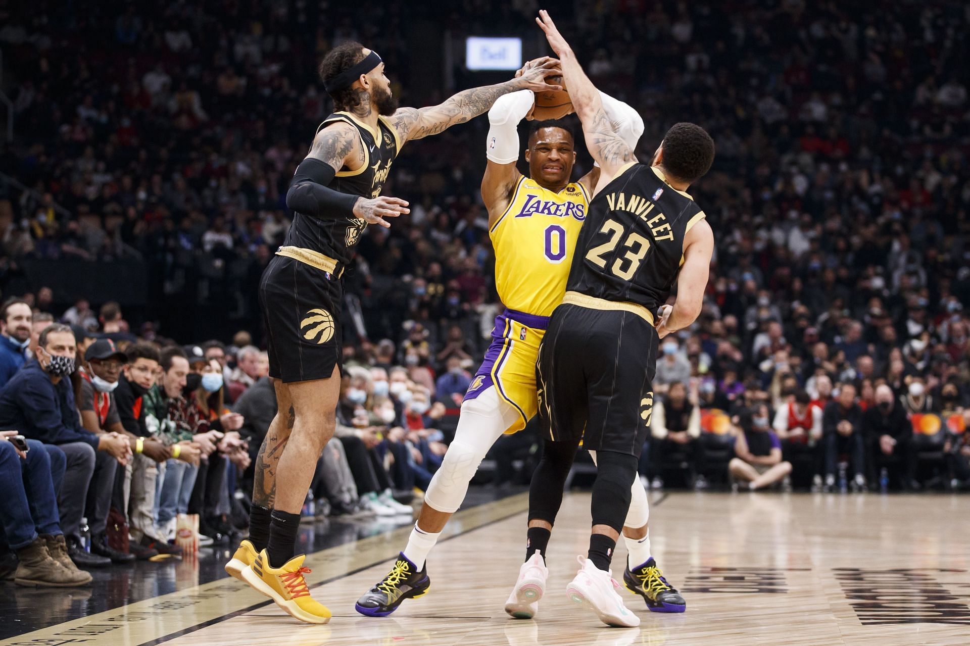 Russell Westbrook (#0) of the Los Angeles Lakers guarded by Fred VanVleet (#23) and Gary Trent Jr. of the Toronto Raptors