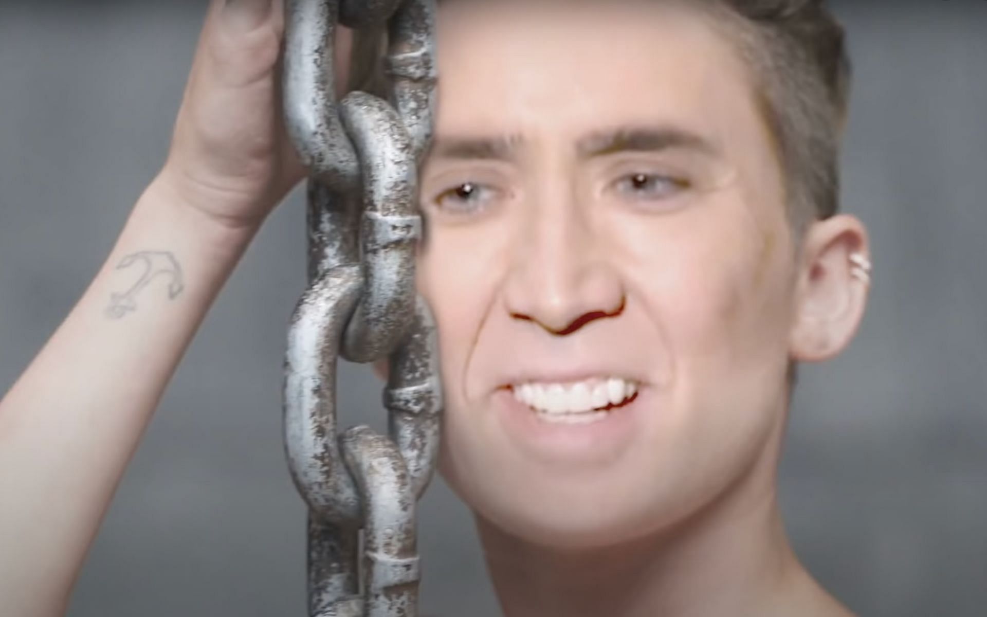 Nicolas Cage&#039;s face plastered on that of Miley Cyrus&#039; in the Wrecking Ball parody (Image via sukmywangBryanStars/YouTube)