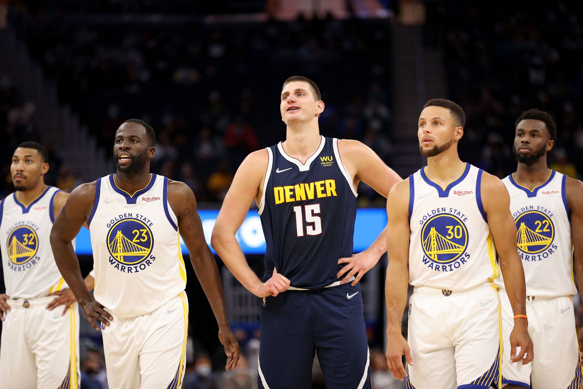 Nikola Jokic of the Denver Nuggets with (L-R) Otto Porter Jr., Draymond Green, Stephen Curry and Andrew Wiggins of the Golden State Warriors
