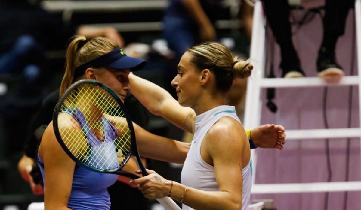 Yastremska and Bogdan embrace at the net after their match.