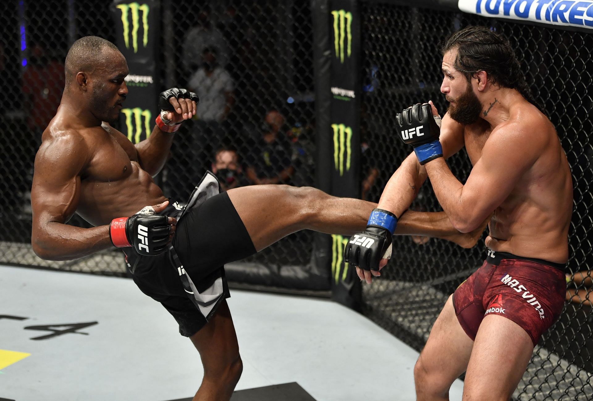 Kamaru Usman kicks Jorge Masvidal in their first fight at UFC 251