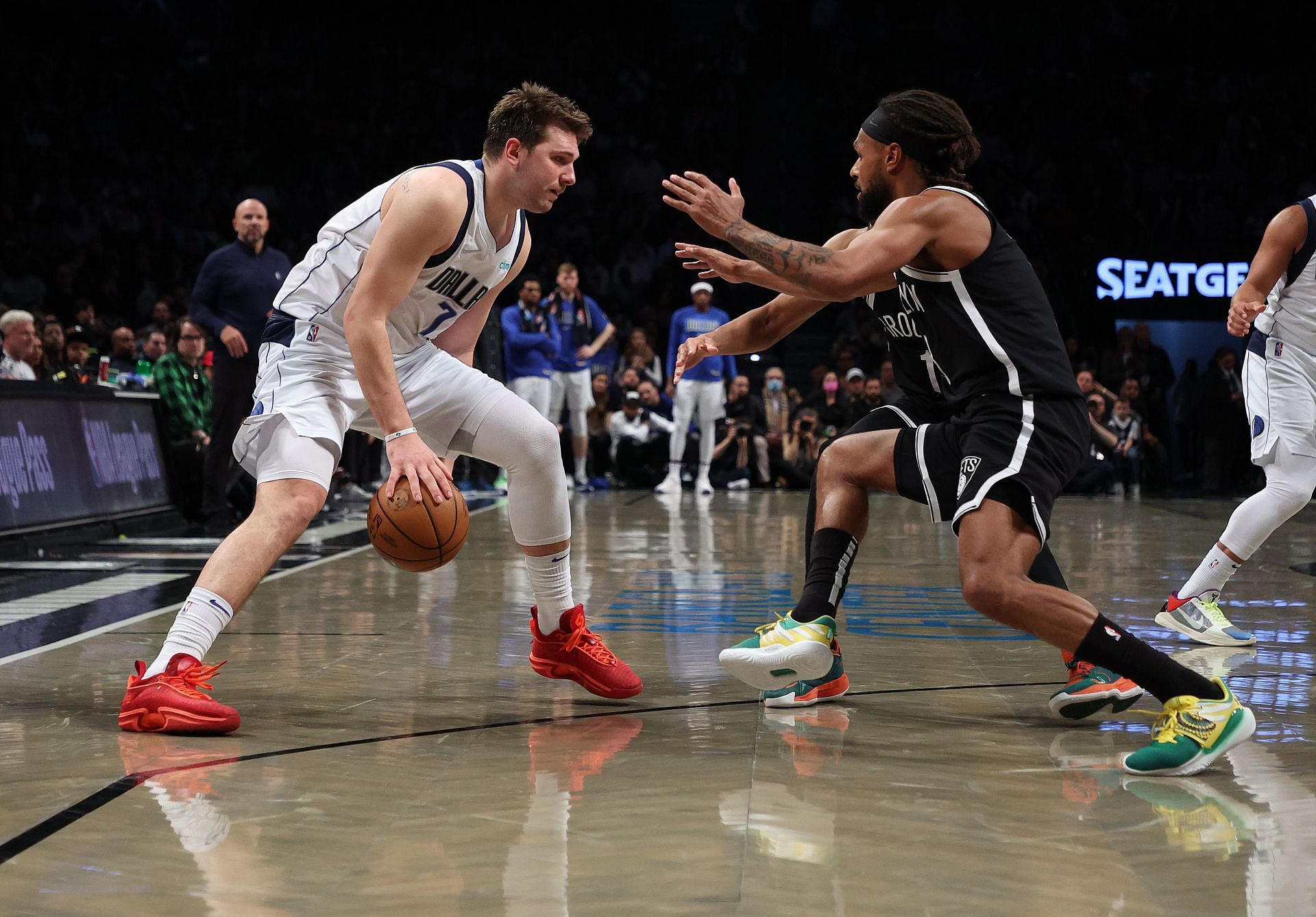 Luka Doncic sizes up Patty Mills on the perimeter.