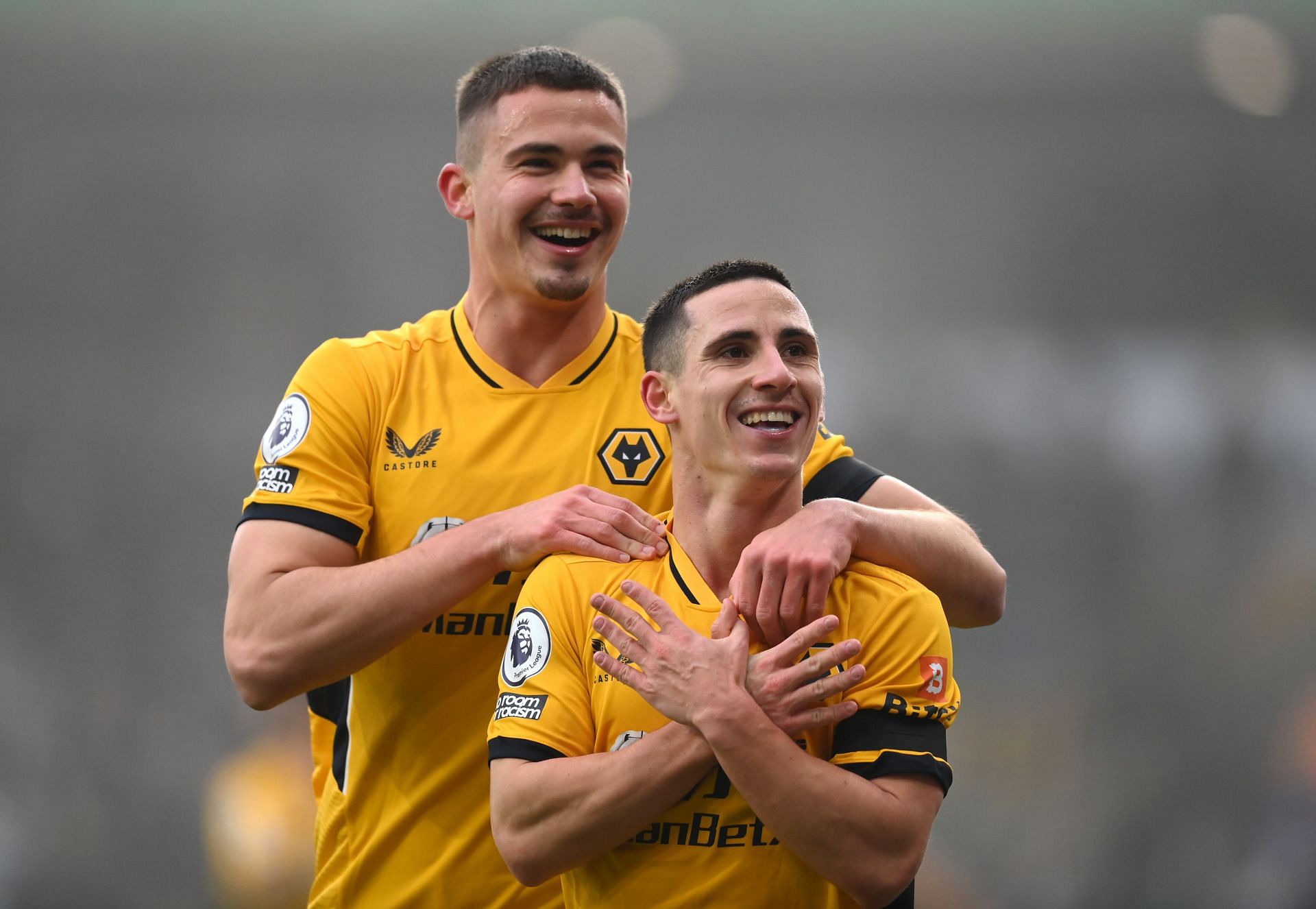Dendoncker (left) celebrates with Wolves teammate Daniel Podence - Premier League