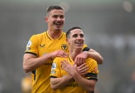 Dendoncker (left) celebrates with Wolves teammate Daniel Podence - Premier League