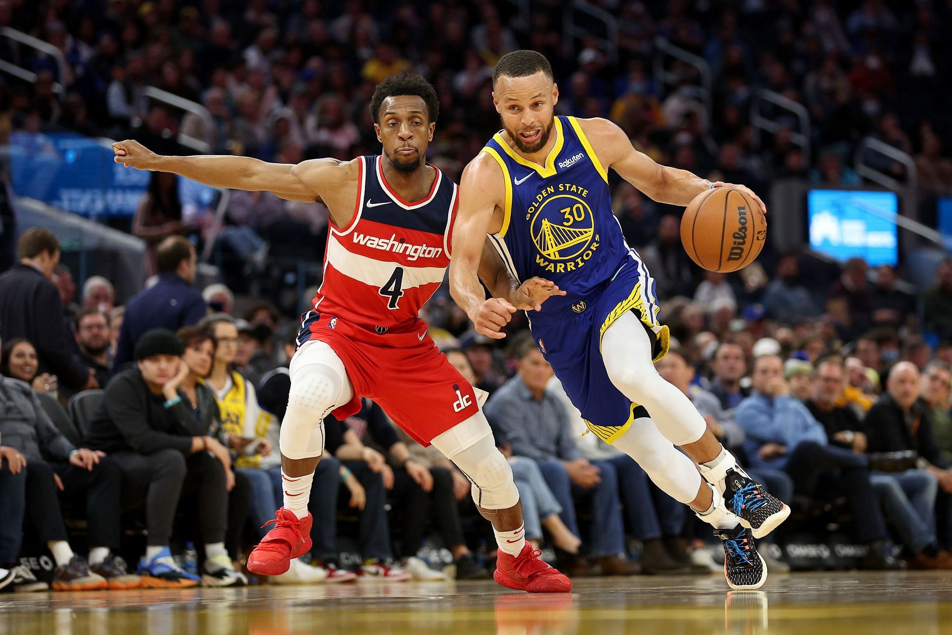 Steph Curry #30 of the Golden State Warriors dribbles past Ish Smith #4 of the Washington Wizards at Chase Center on March 14, 2022 in San Francisco, California.