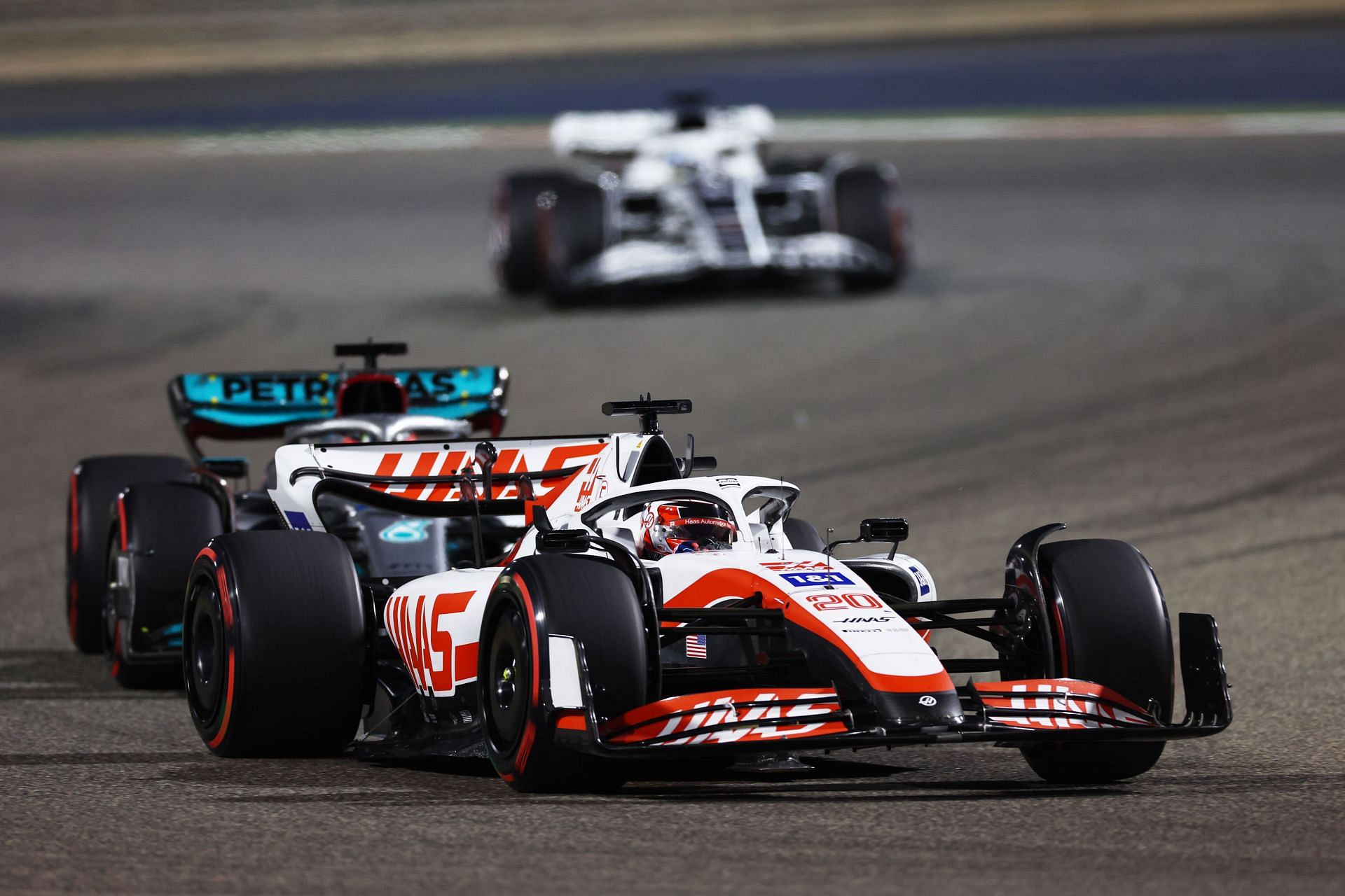 Kevin Magnussen (#20) Haas VF-22 defends against George Russell (#63) Mercedes W13, 2022 Bahrain Grand Prix