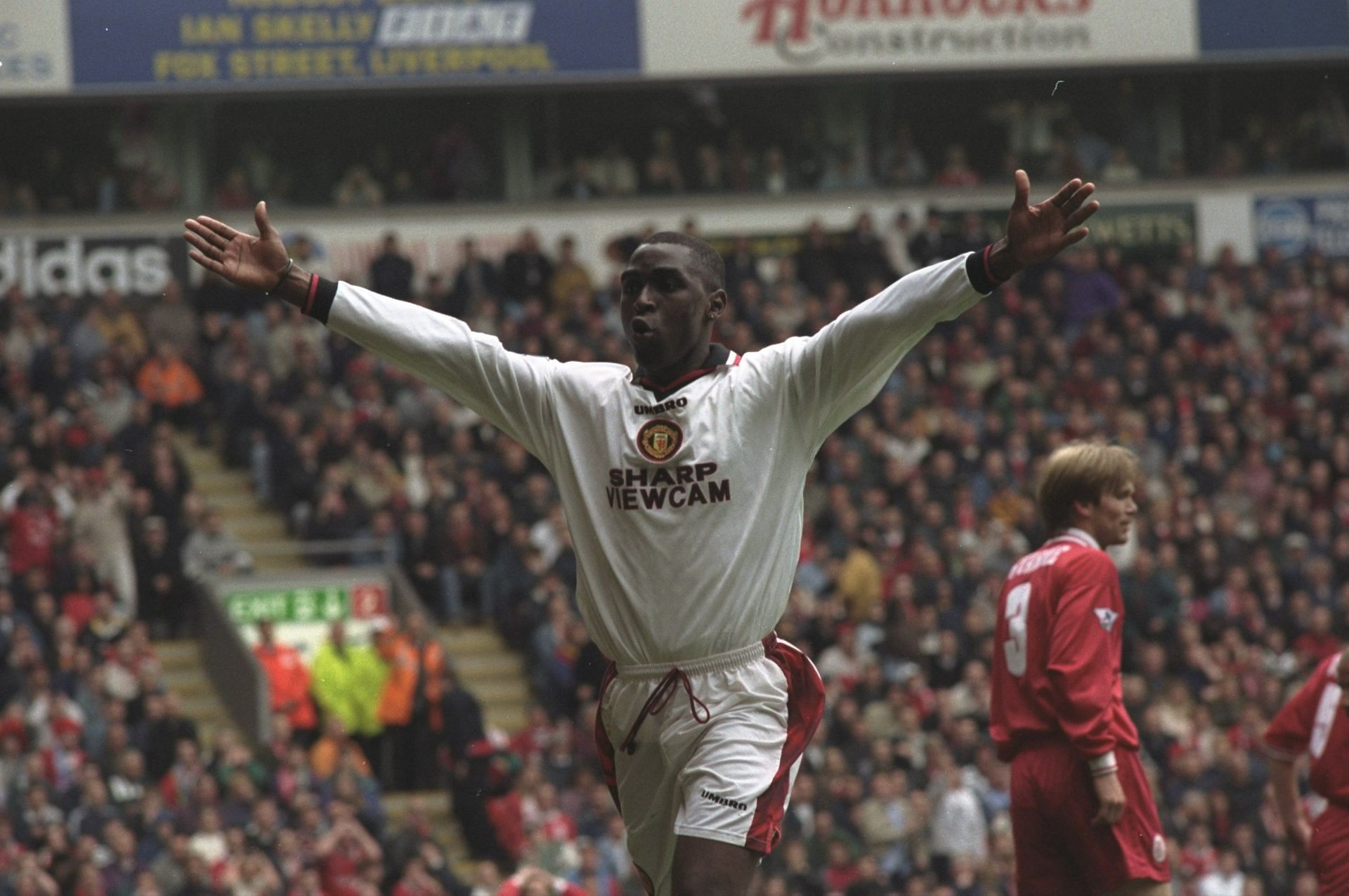 Andy Cole celebrates against Liverpool