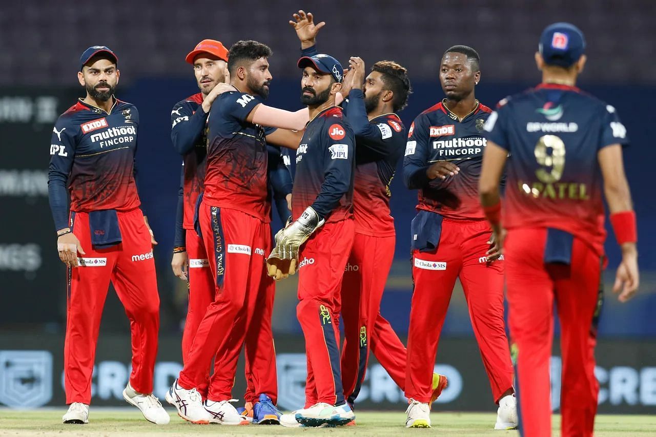 Mohammed Siraj celebrates a wicket with his teammates