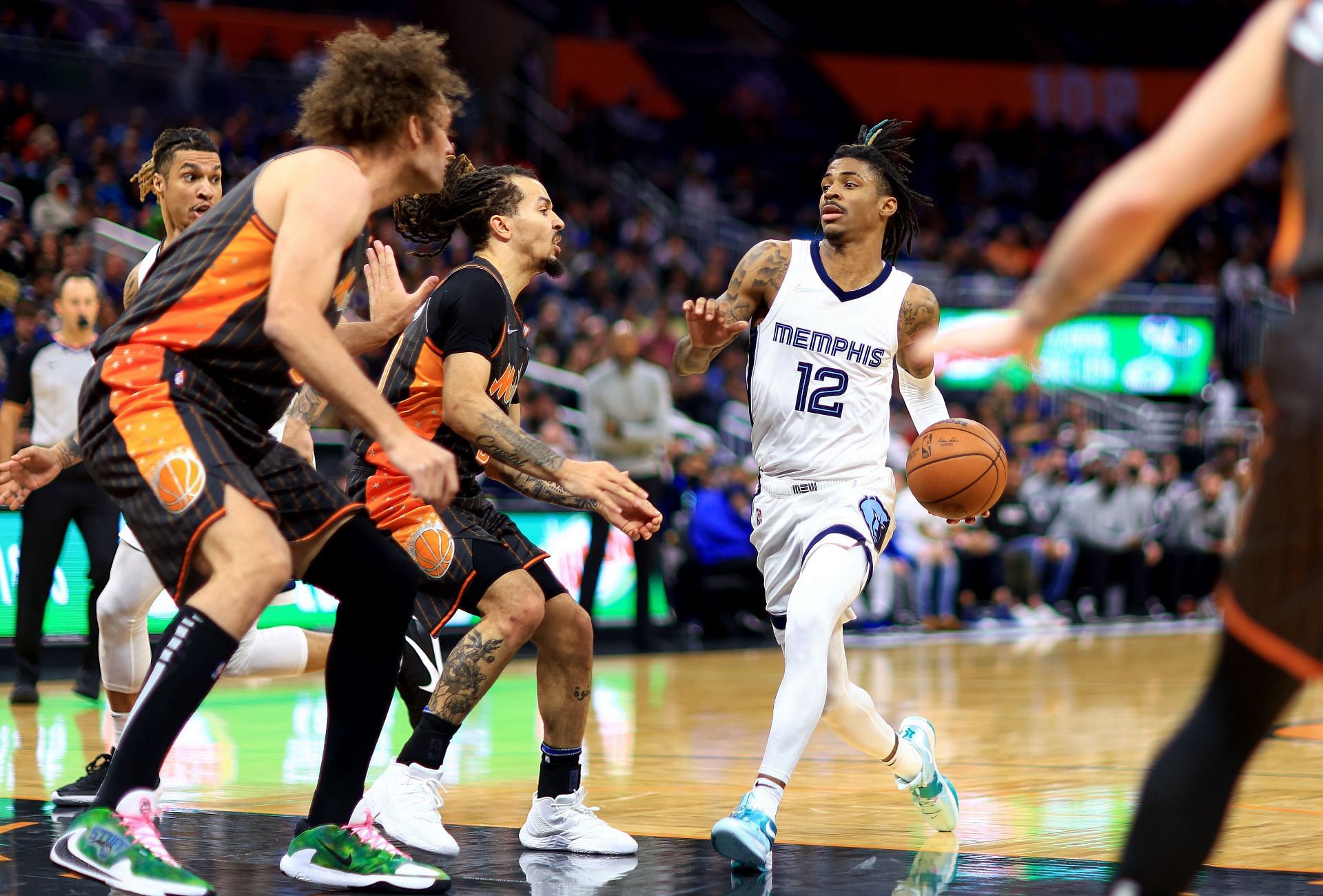 Morant #12 of the Memphis Grizzlies drives to the basket during a game against the Orlando Magic