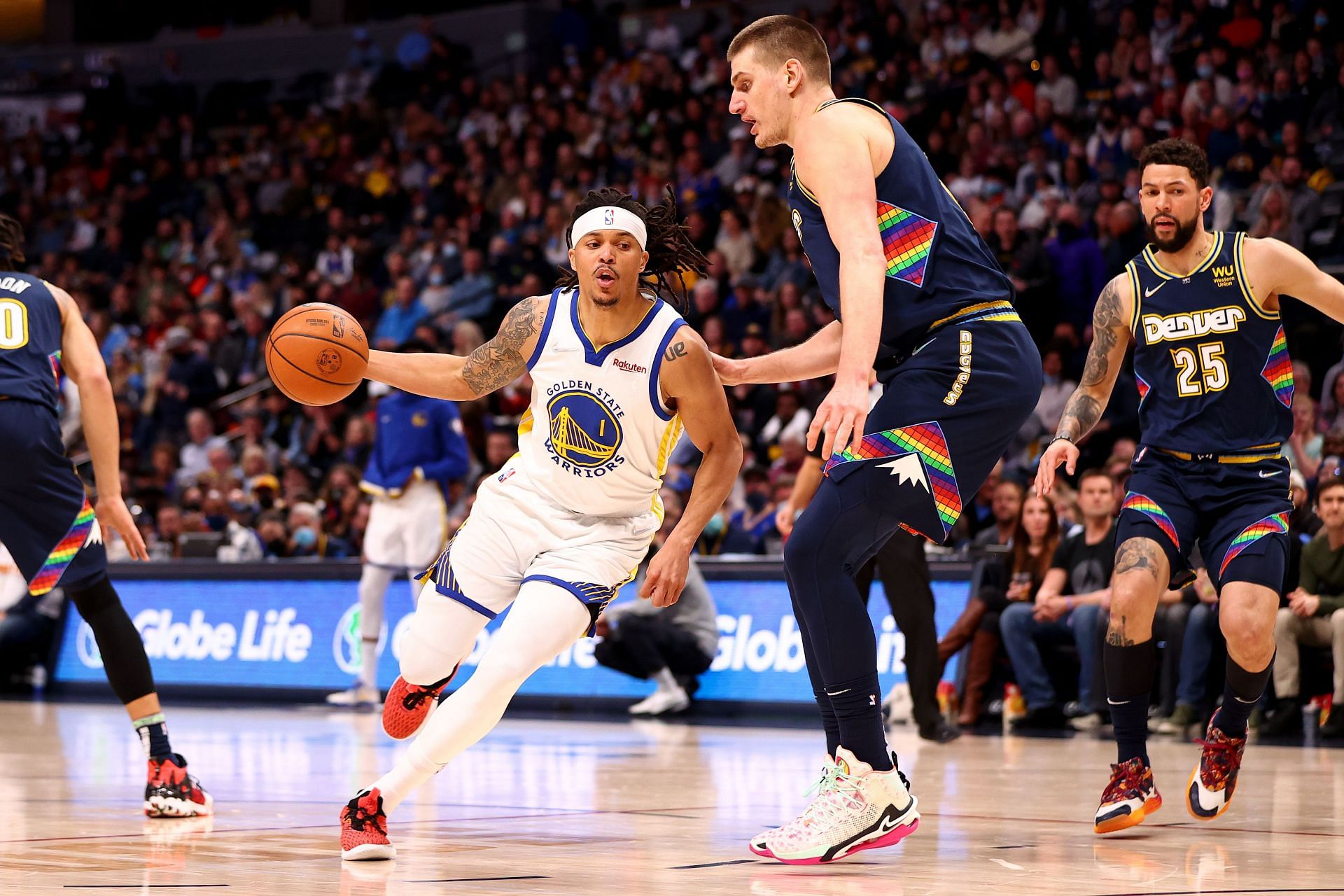 Damion Lee #1 of the Golden State Warriors drives against Nikola Jokic #15 of the Denver Nuggets