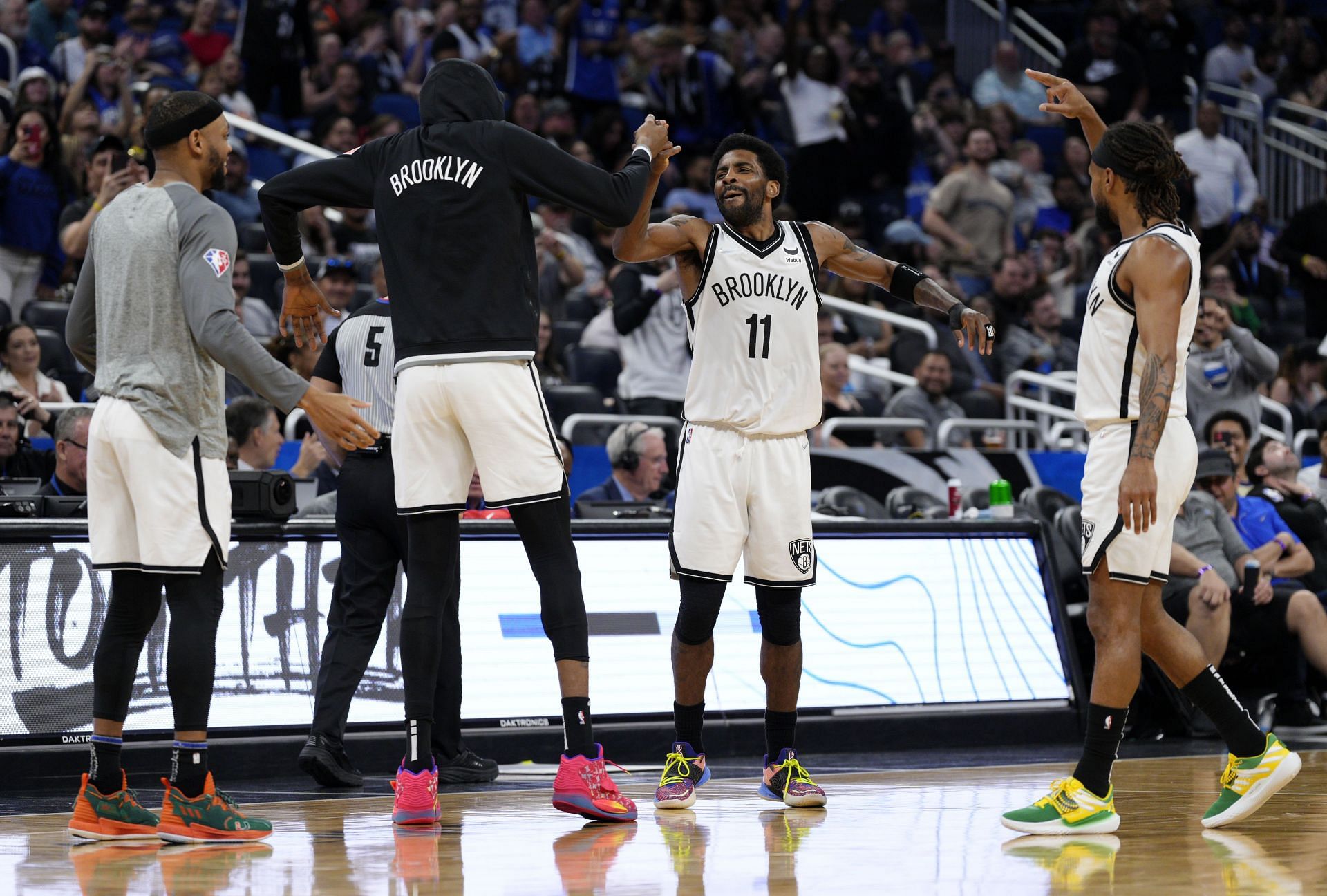 Kyrie Irving #11 of the Brooklyn Nets celebrates with Bruce Brown #1, Kevin Durant #7 and Patty Mills #8