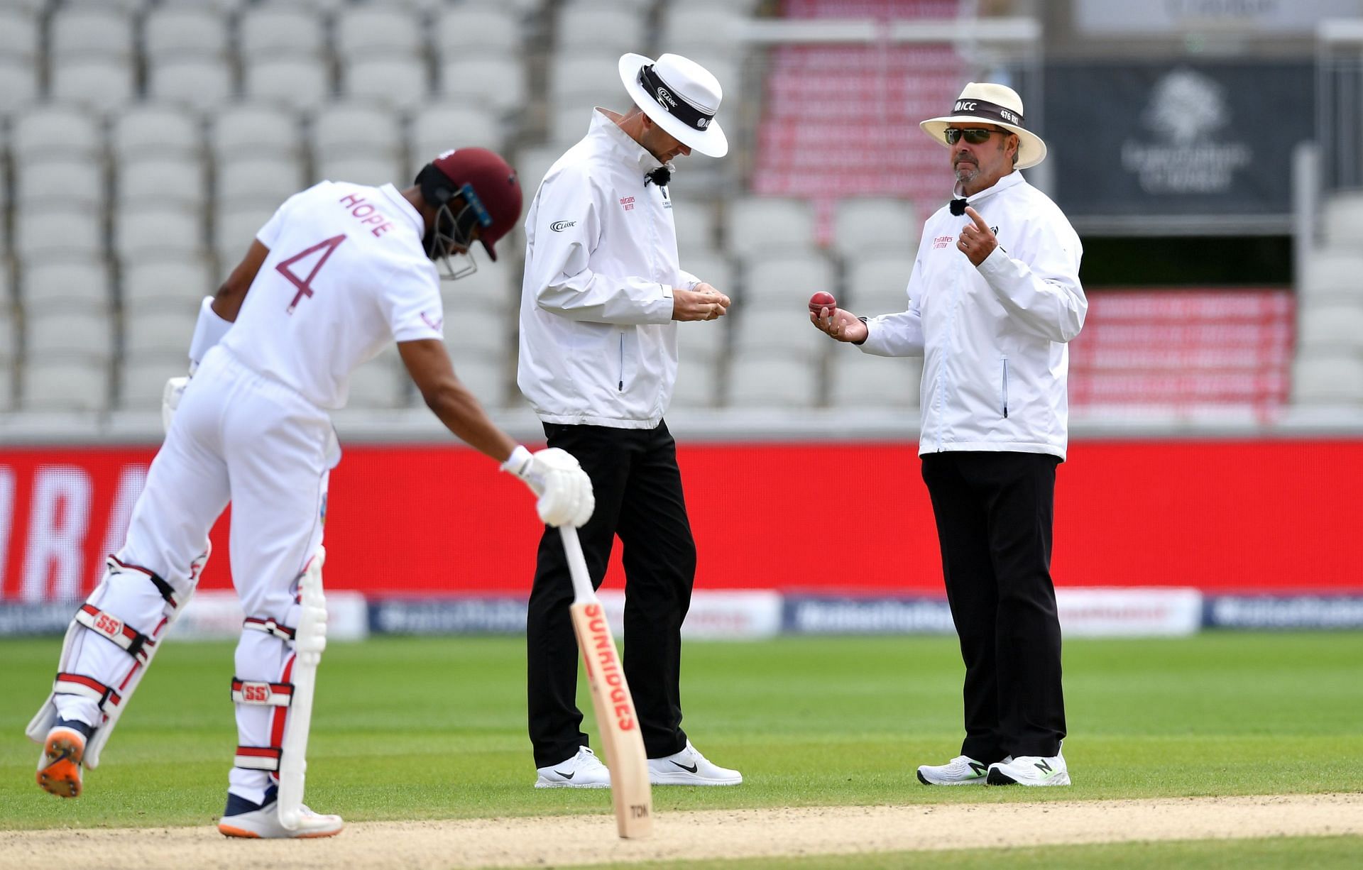 Umpires sanitize the ball after saliva is accidentally added to it during a Test at Old Trafford in July 2020. Pic: Getty Images