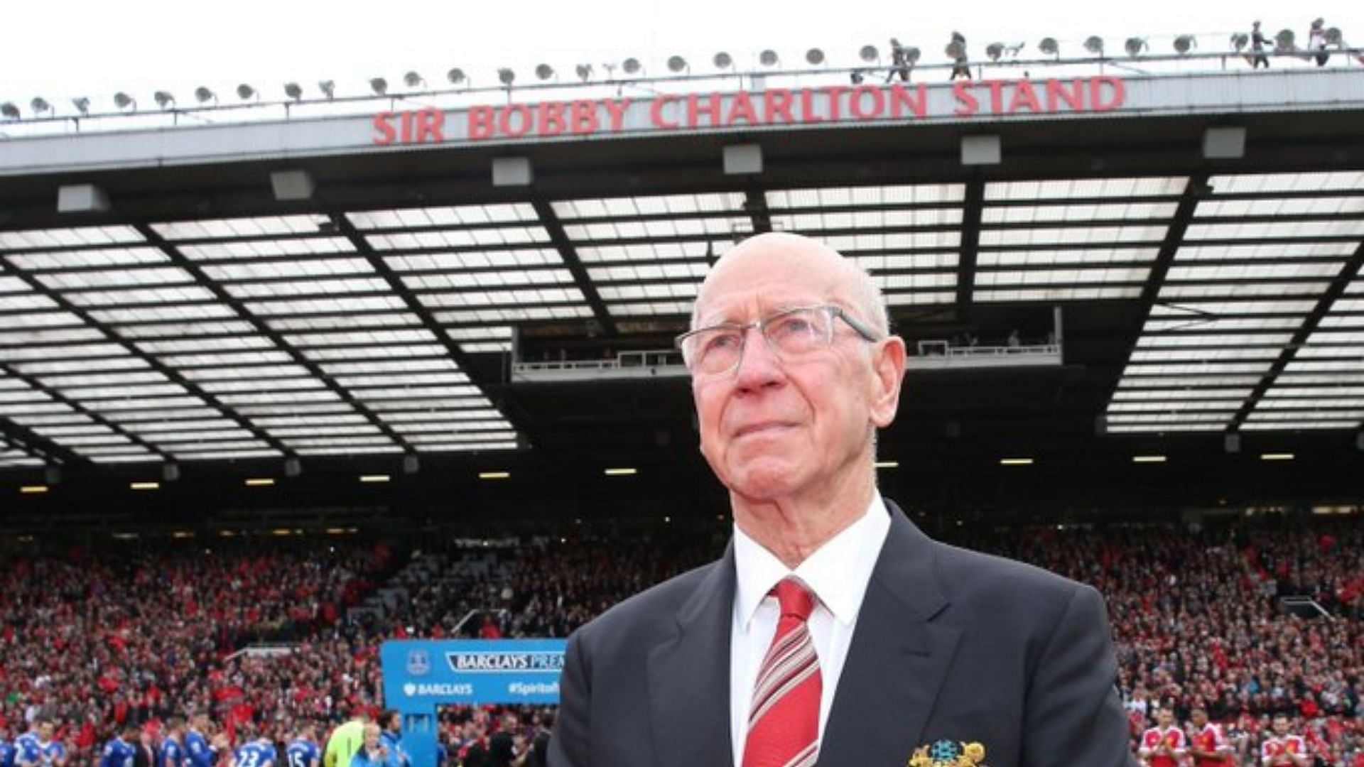 Sir Bobby Charlton in 2016, in front of the stand named after him