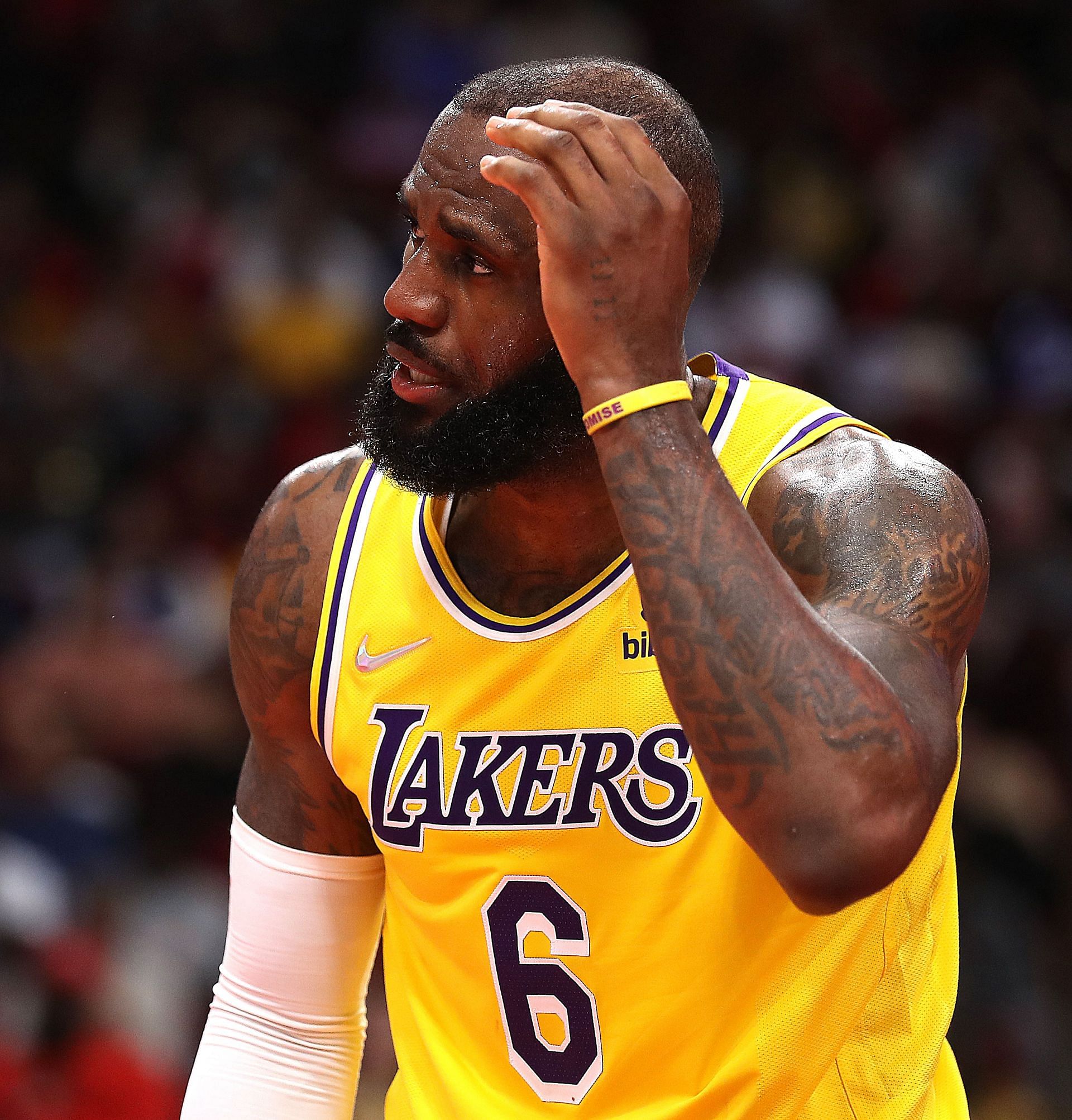 LeBron James #6 of the Los Angeles Lakers hold his head after he was hit going to the basket against the Houston Rockets during the fourth quarter at Toyota Center on March 09, 2022 in Houston, Texas.